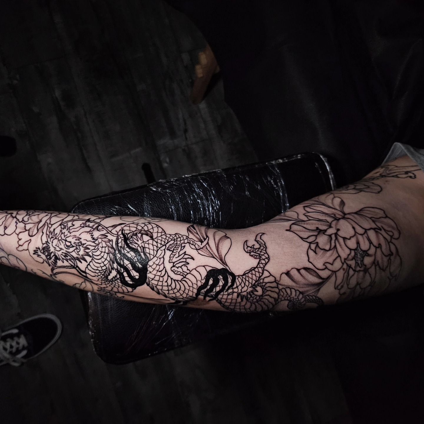 Dragon and flowers black and grey tattoo on the forearm by Gabrielle Esperanza ☽。⋆