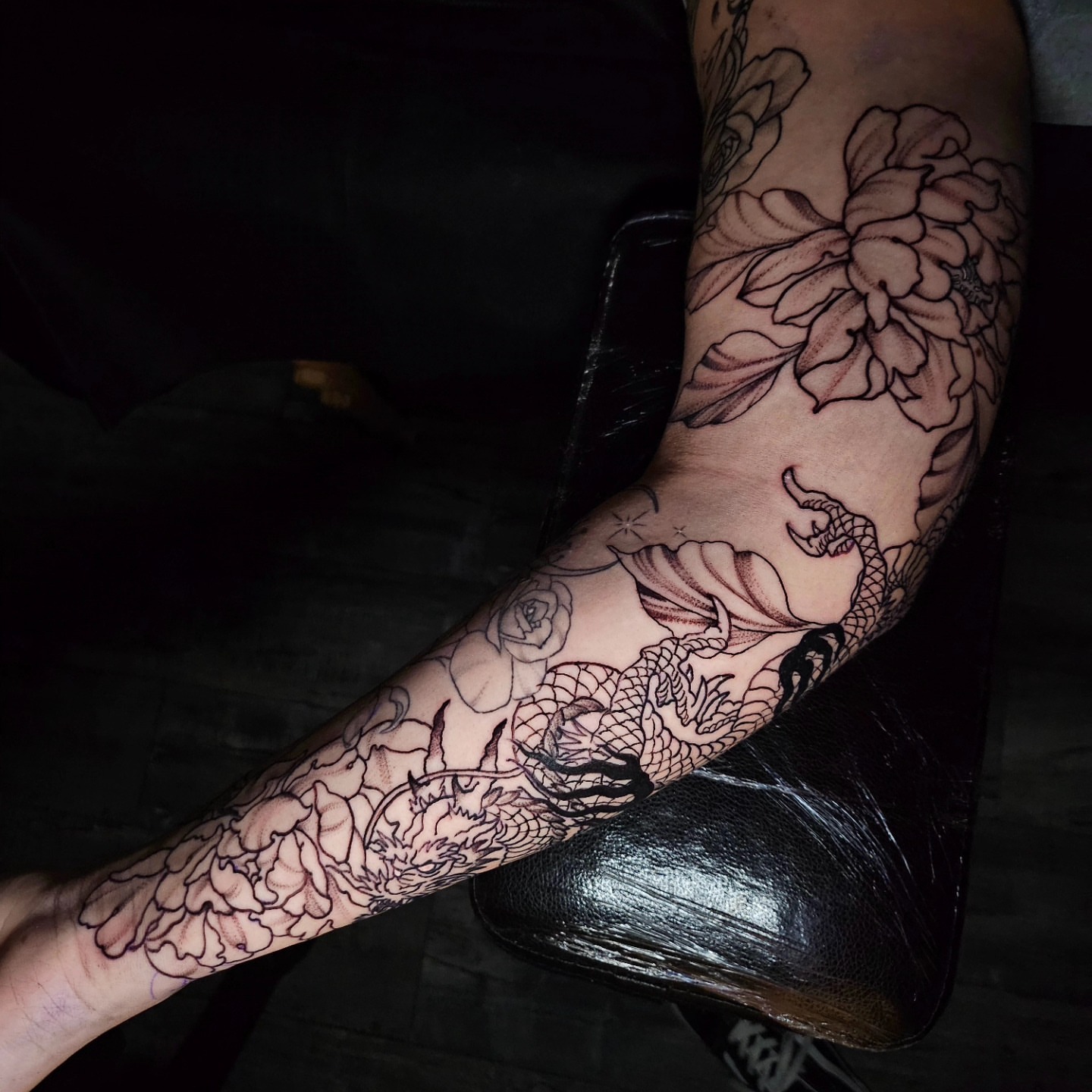 Dragon and flowers black and grey tattoo on the forearm by Gabrielle Esperanza ☽。⋆