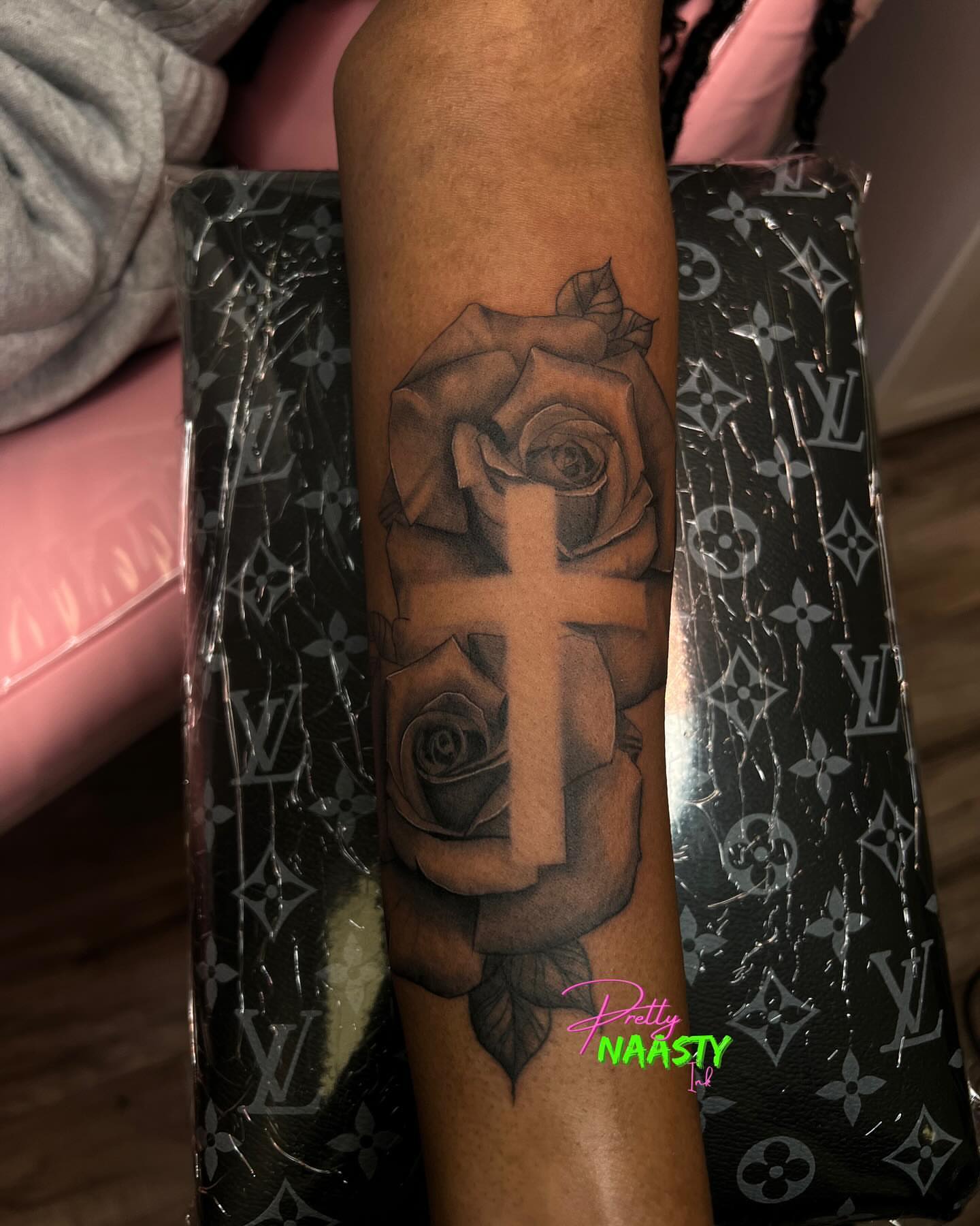 Cross and roses black and grey tattoo on the forearm by Pretty Naasty Ink🖤