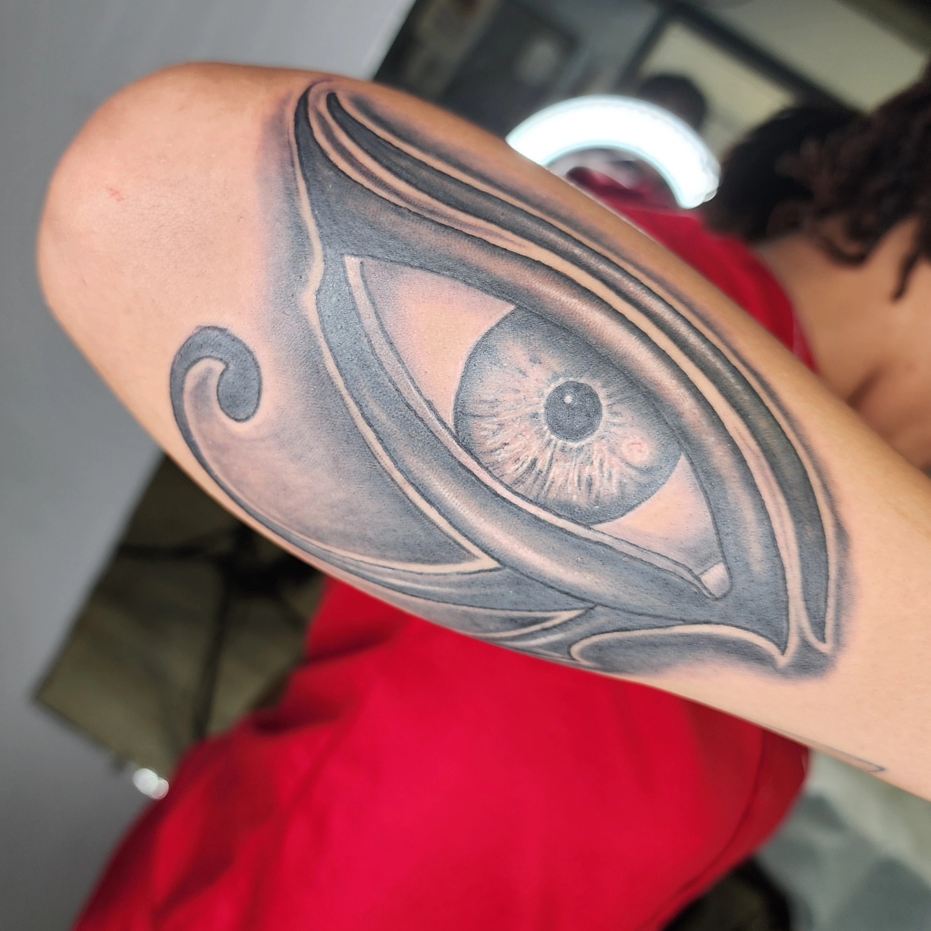 Eye black and grey tattoo on the forearm by Zach Mullins