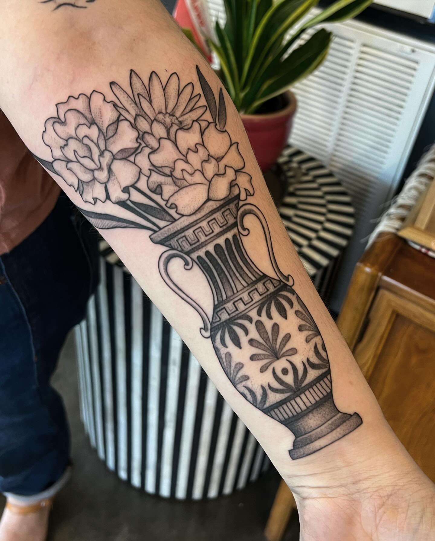 Flowers in vase black and grey tattoo on the forearm by Will Campbell