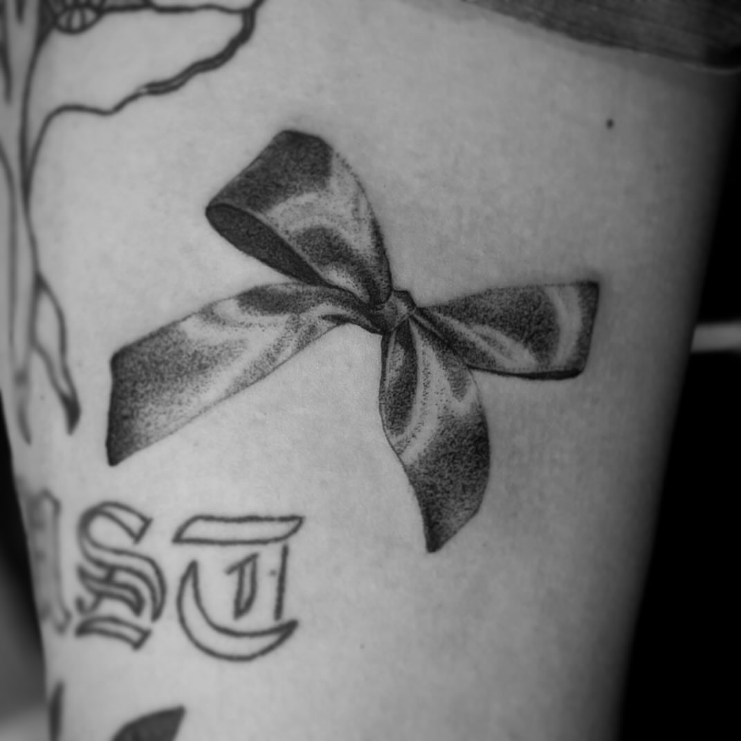 Bow dotwork tattoo on the forearm by Lee Ranco