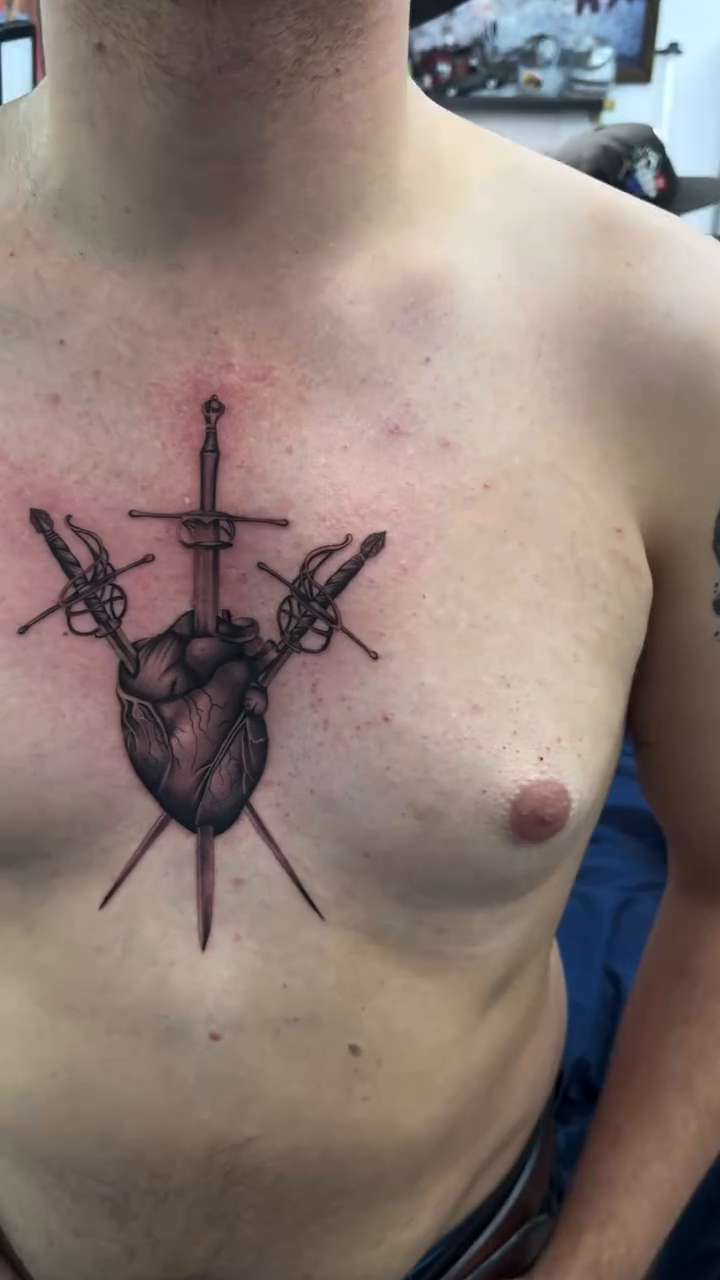 Anatomical heart with swords dark realism tattoo by Cesar Nava