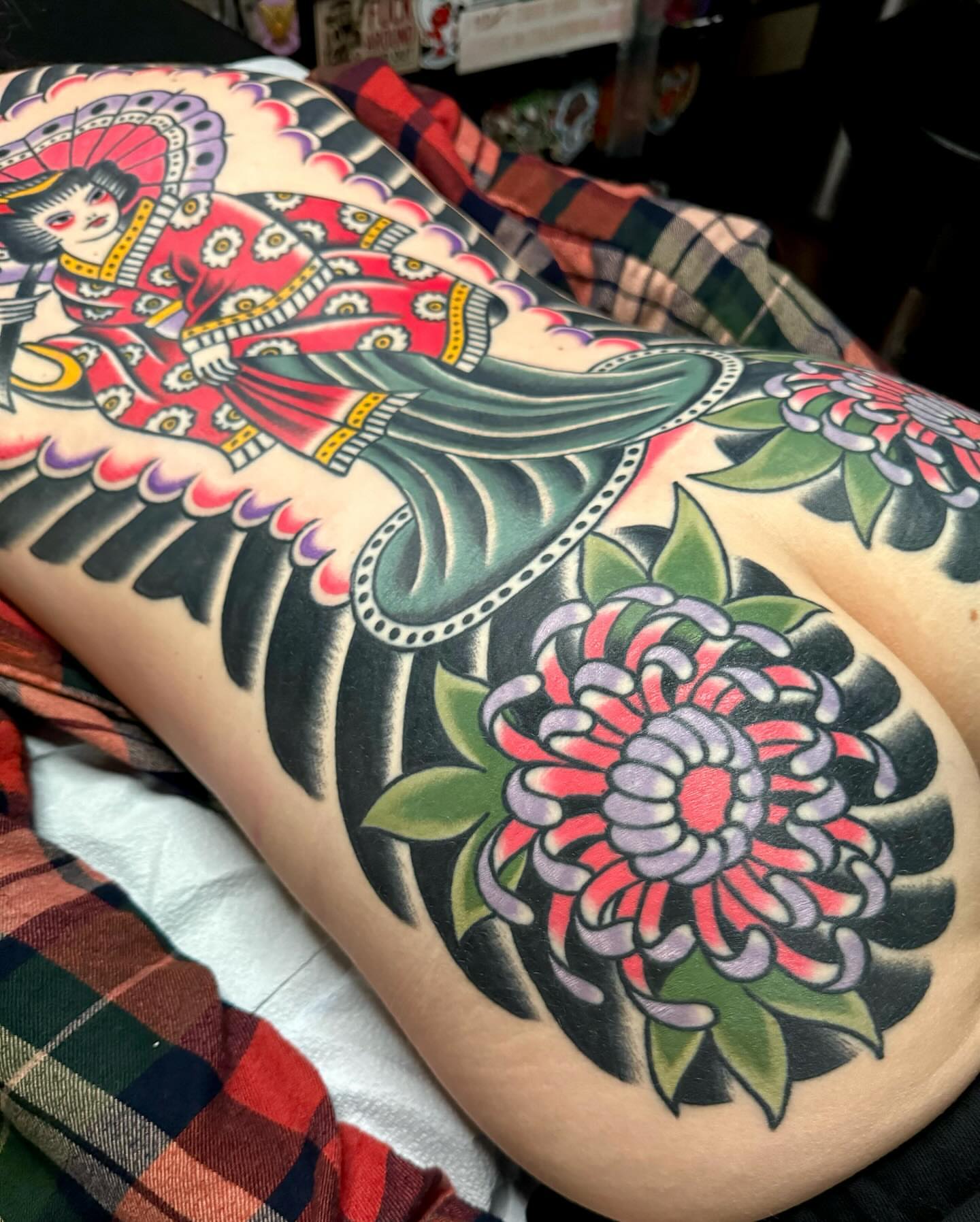 Geisha and chrysanthemum American traditional tattoo on the thigh by James Shepherd, Austin, Texas