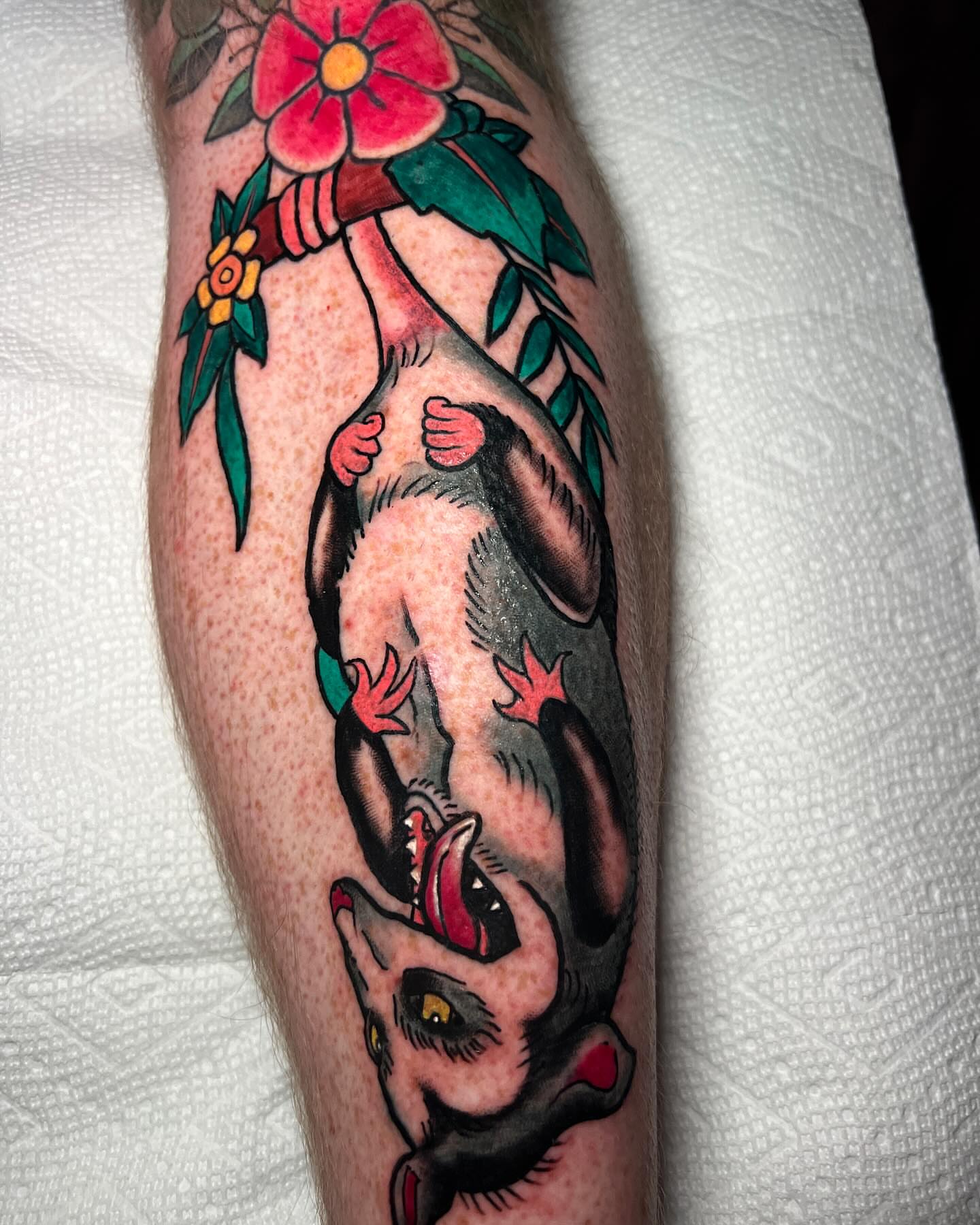 Rat hanging upside down American traditional tattoo on the forearm by Lucky Valenzuela, Lakewood, Colorado