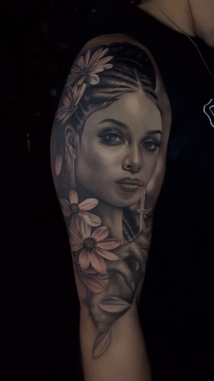 Portrait of a woman with flowers realism tattoo by Ana Reyes