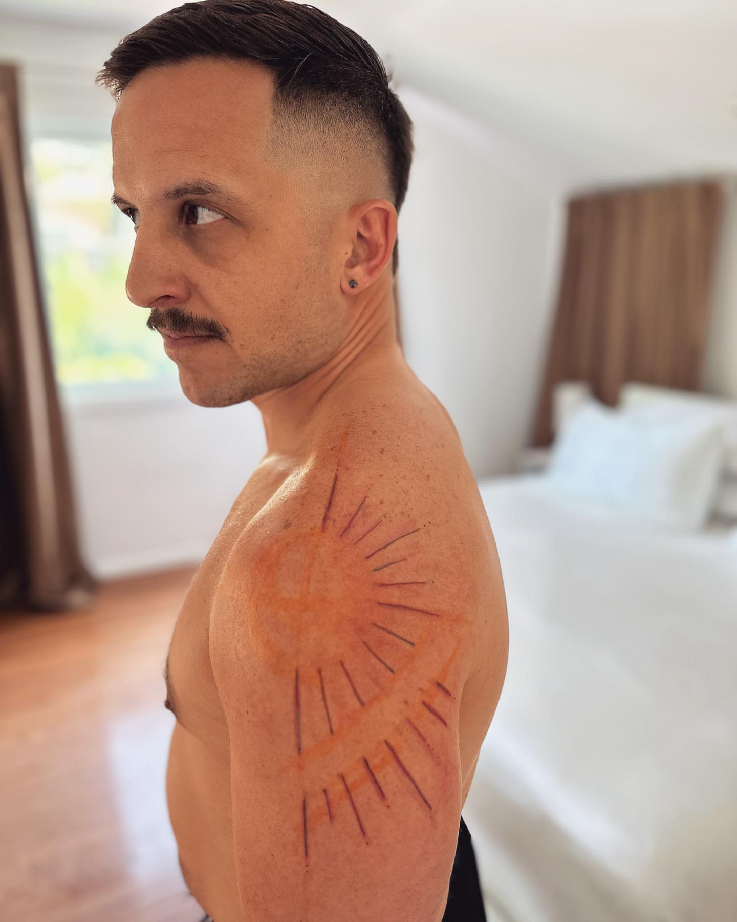 Sunburst geometric tattoo on the shoulder by Gaya