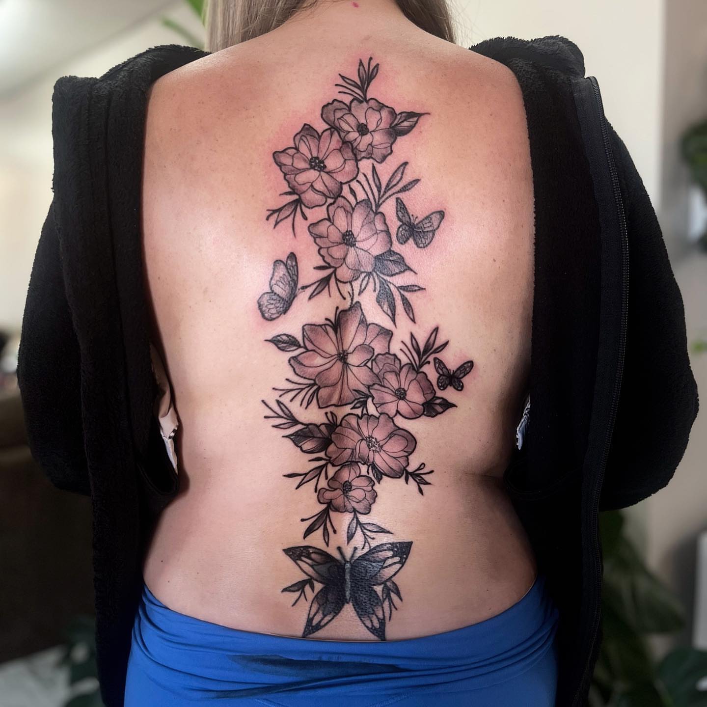 Flowers and butterflies black and grey tattoo on the back by π΅πππππ