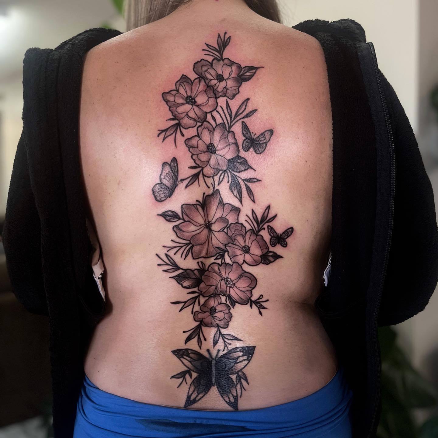 Flowers and butterflies black and grey tattoo on the back by π΅πππππ