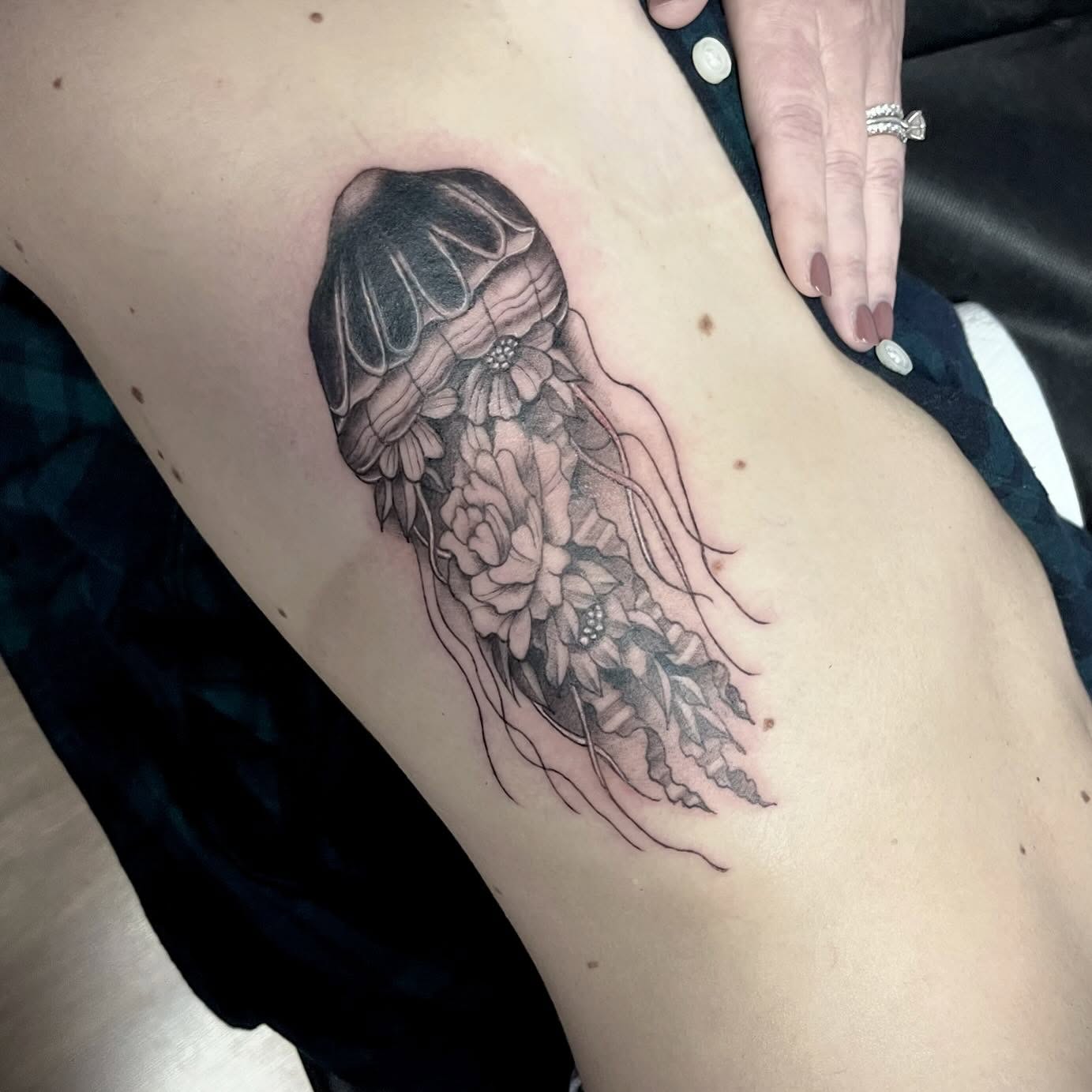 Jellyfish with floral elements realism tattoo on the thigh by Ashly Hutchens, Richmond, Virginia