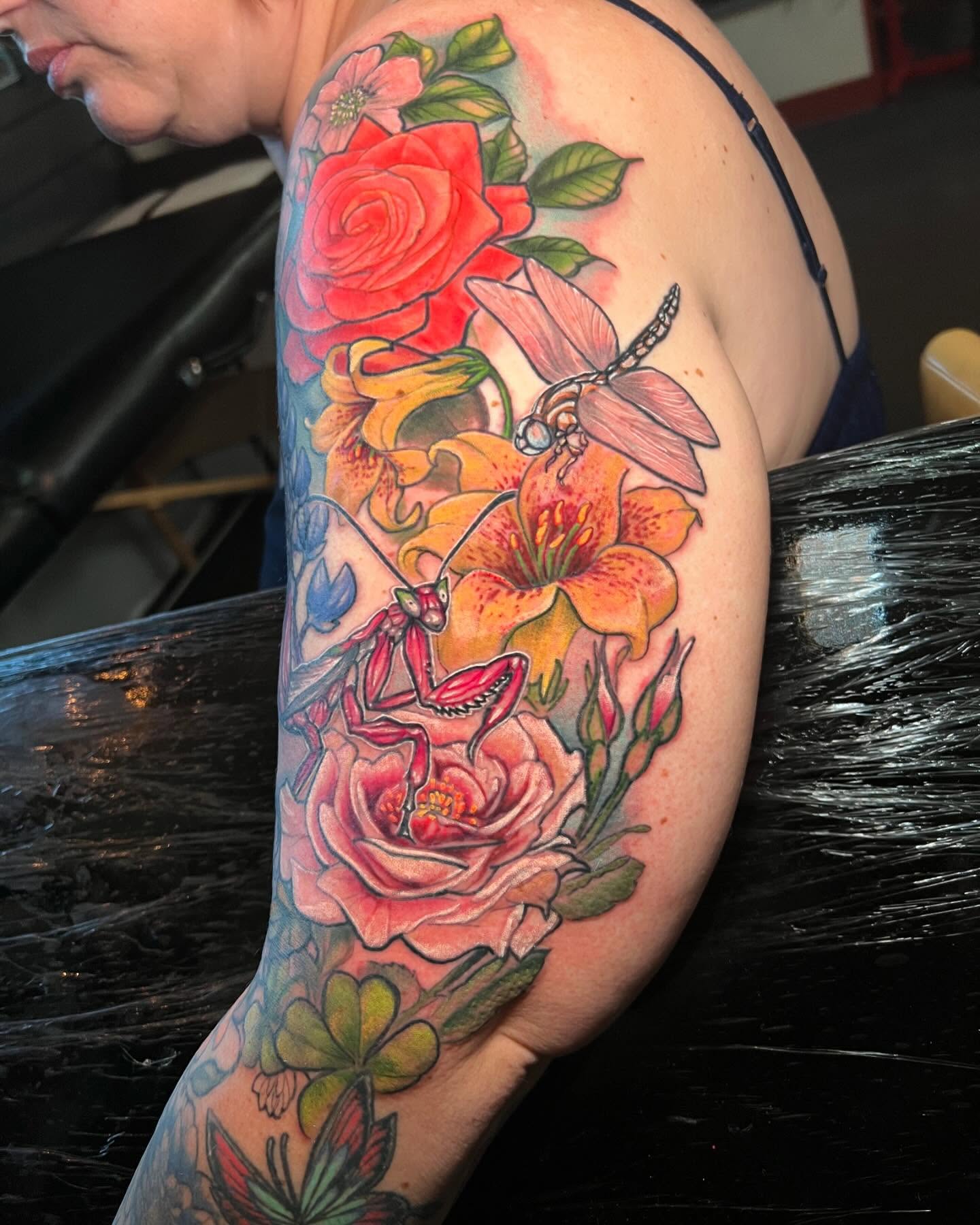 Floral arrangement realism tattoo on the forearm by Josh Green