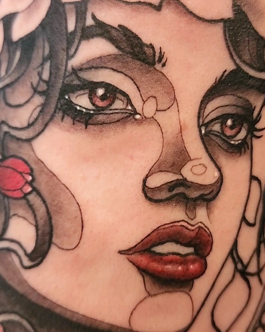 Woman's face American traditional tattoo on the head by Mario Romero