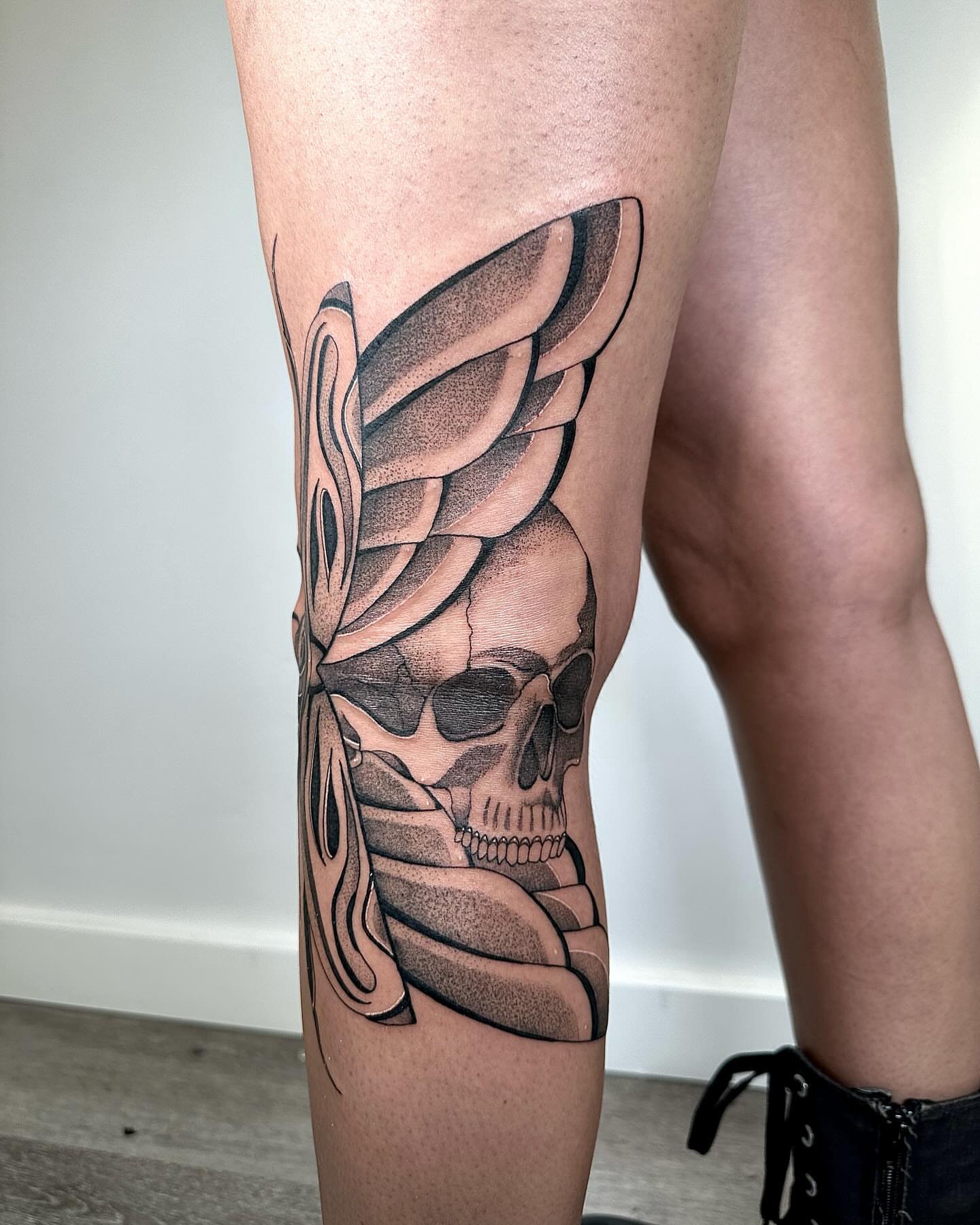 Skull with wings dotwork tattoo on the thigh by Fine line tattoo San Diego, San Diego, California