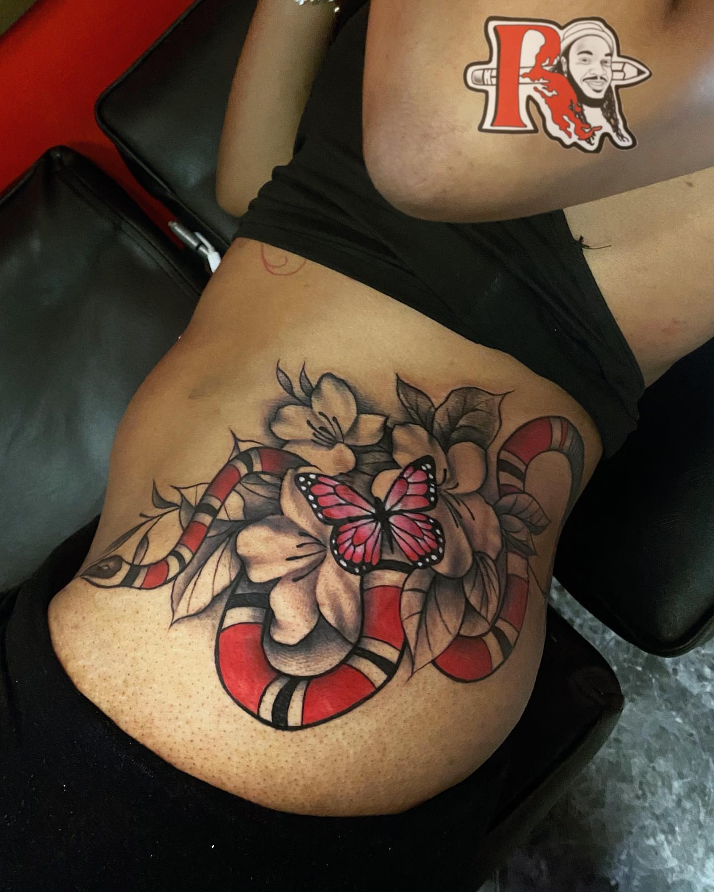 Snake and butterfly realism tattoo on the thigh by Chicago Tattoo Artist