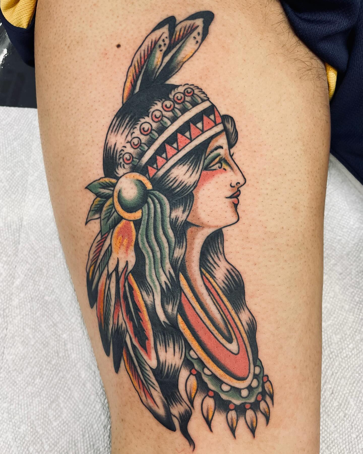 Indian headdress American traditional tattoo on the thigh by Dave G