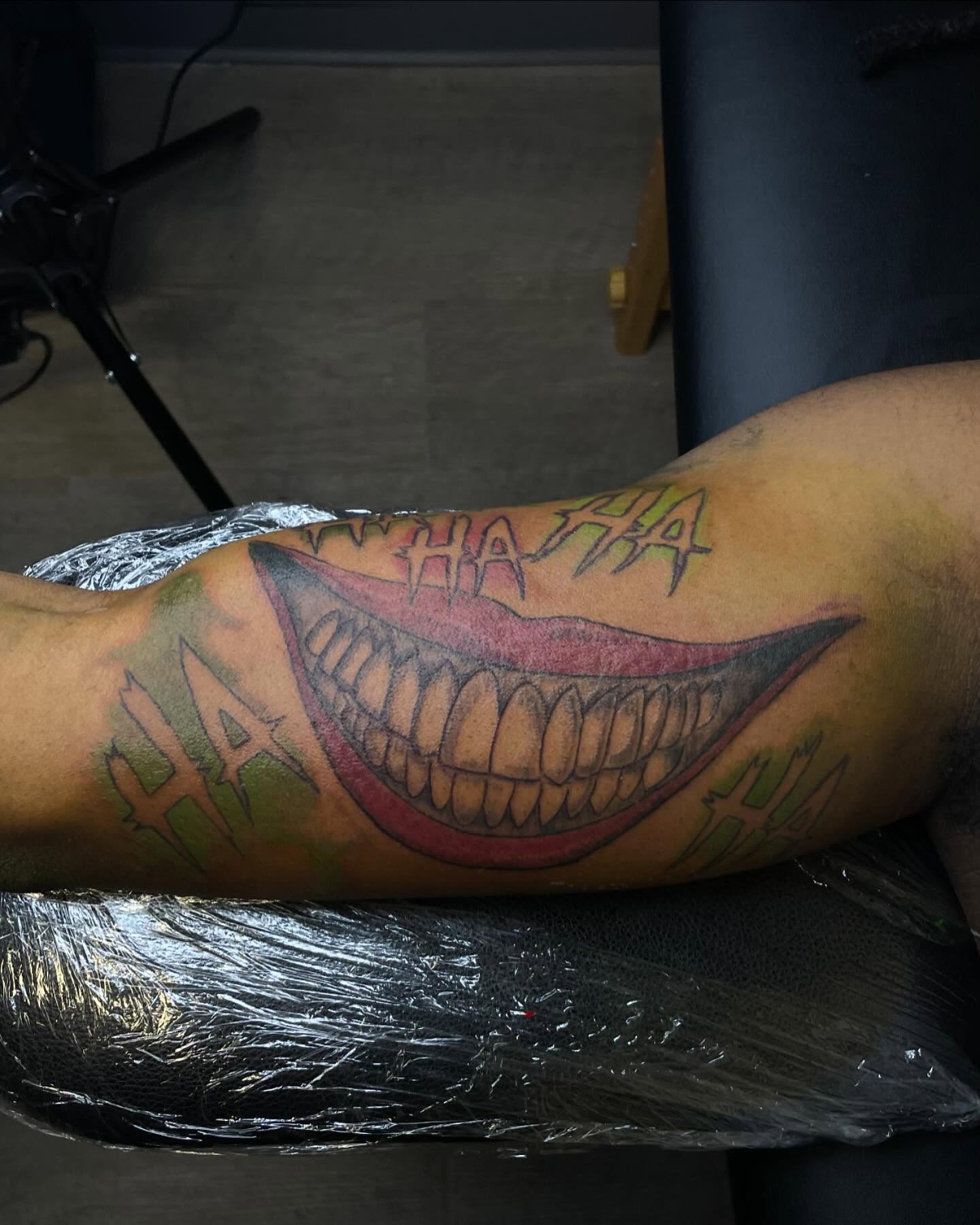 Grinning mouth American traditional tattoo on the forearm by Dinero Inks