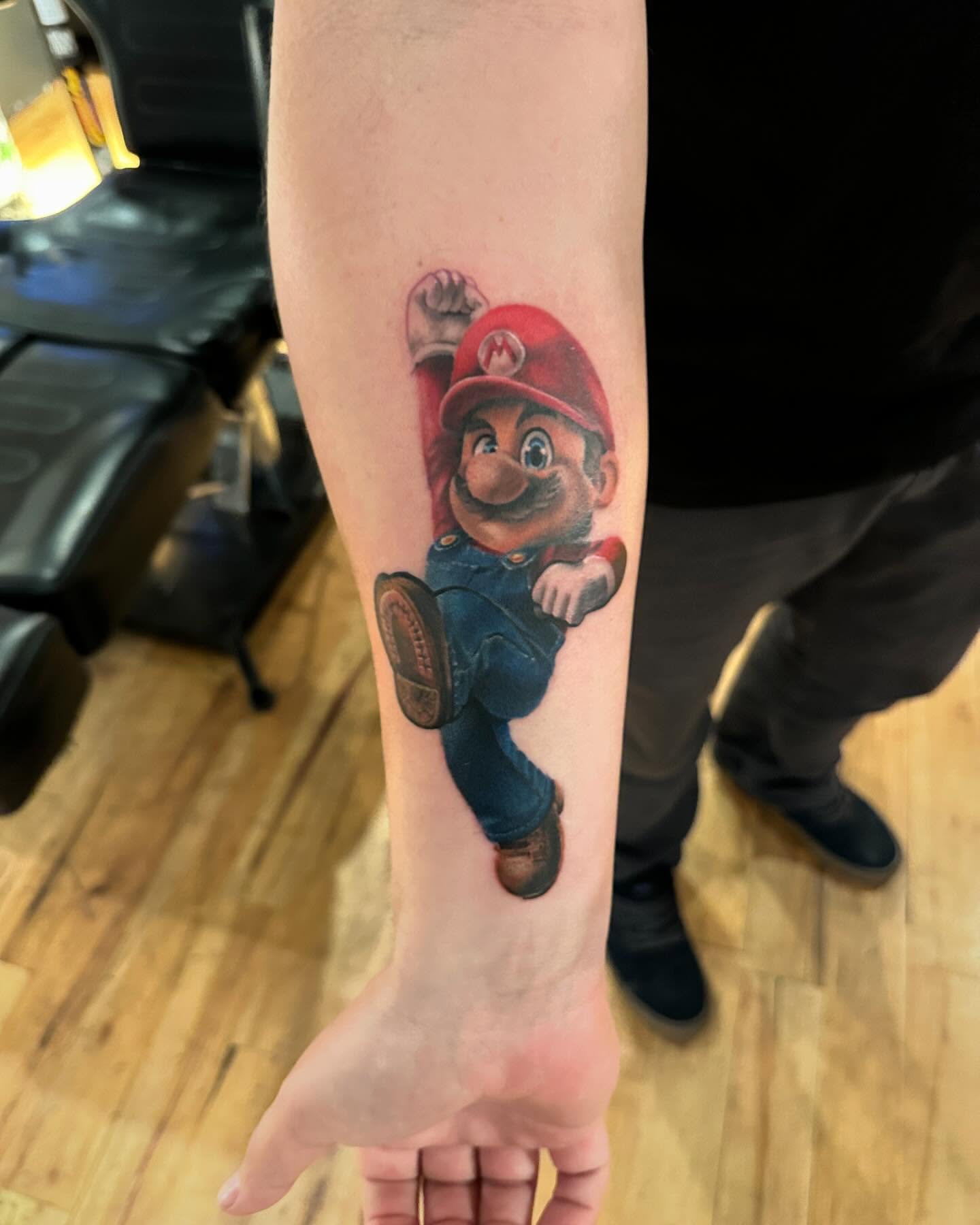 Mario realism tattoo on the forearm by Jeff Kees