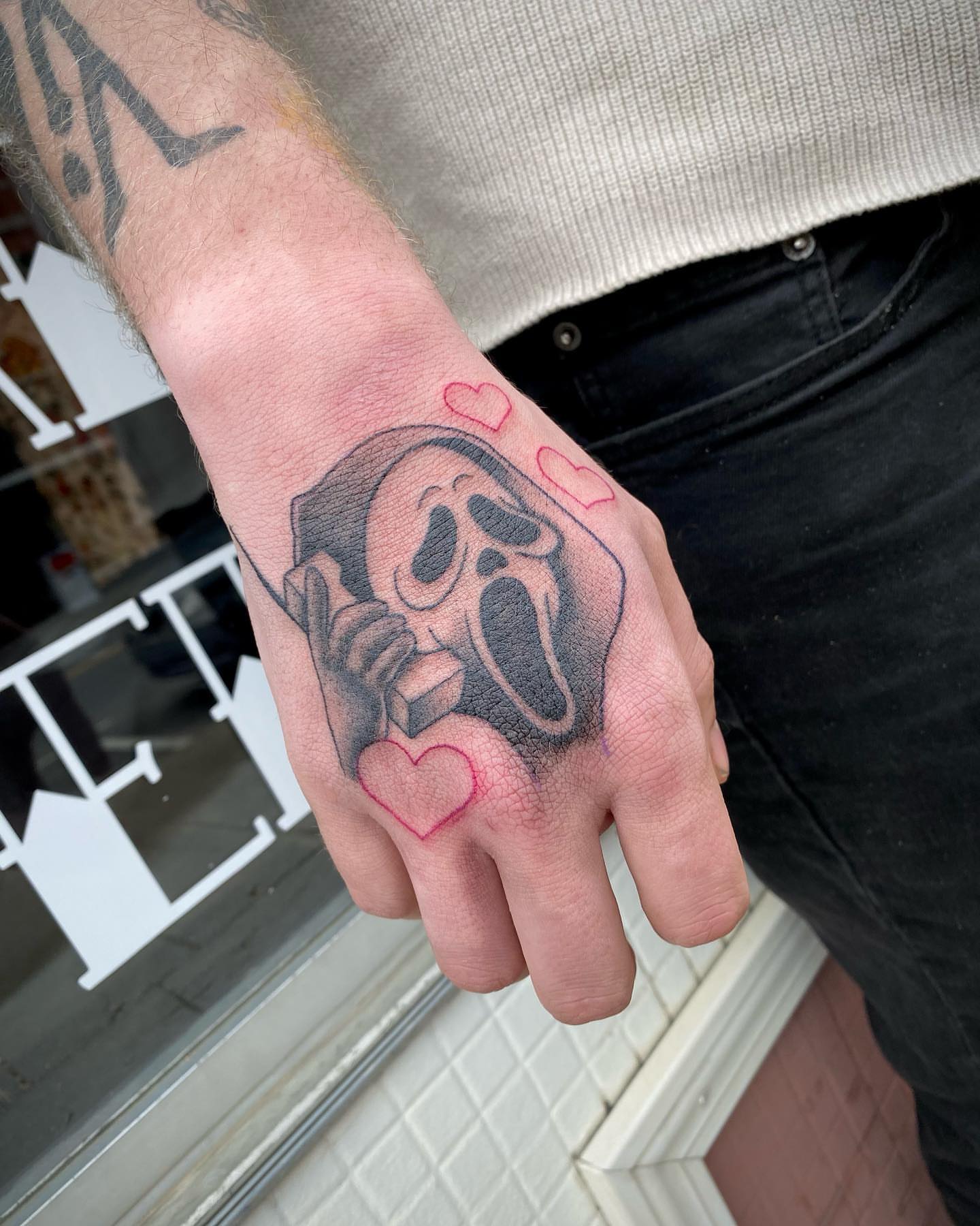 Scream ghost black and grey tattoo on the hand by Savanna Starr Mortensen