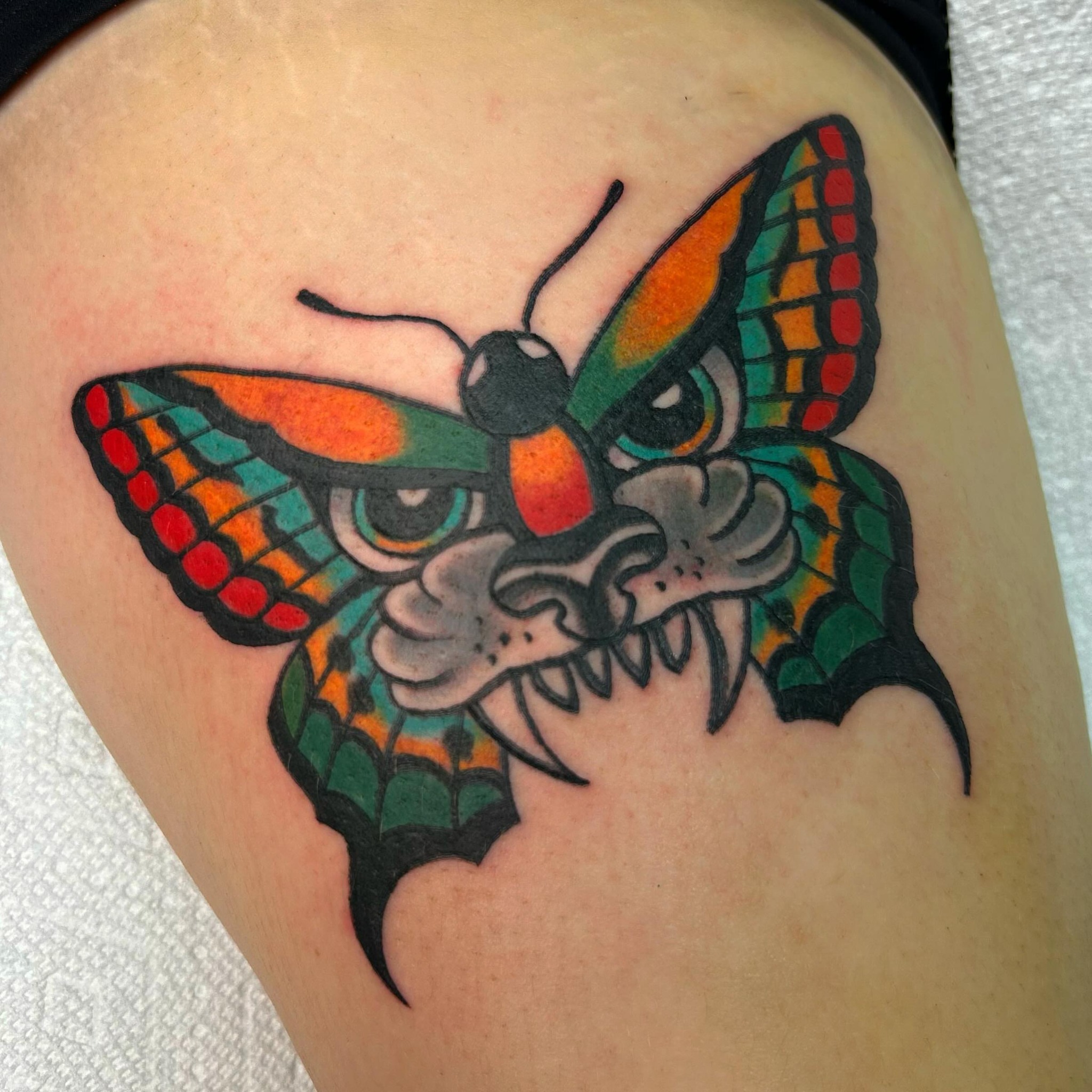 Butterfly American traditional tattoo on the thigh by Lauren Caldwell 🔮🌙