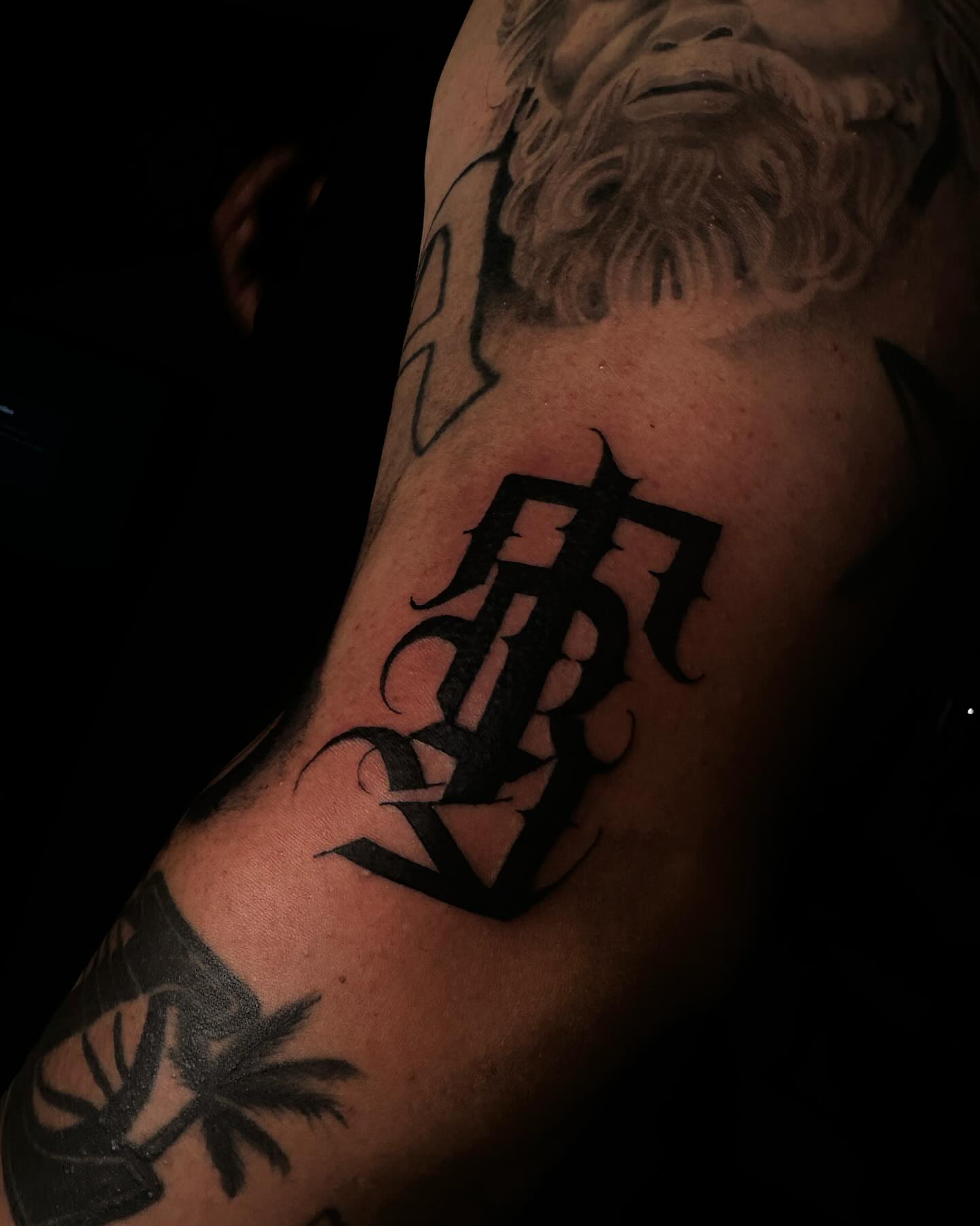 Gothic lettering black and grey tattoo on the forearm by Bree Quirino