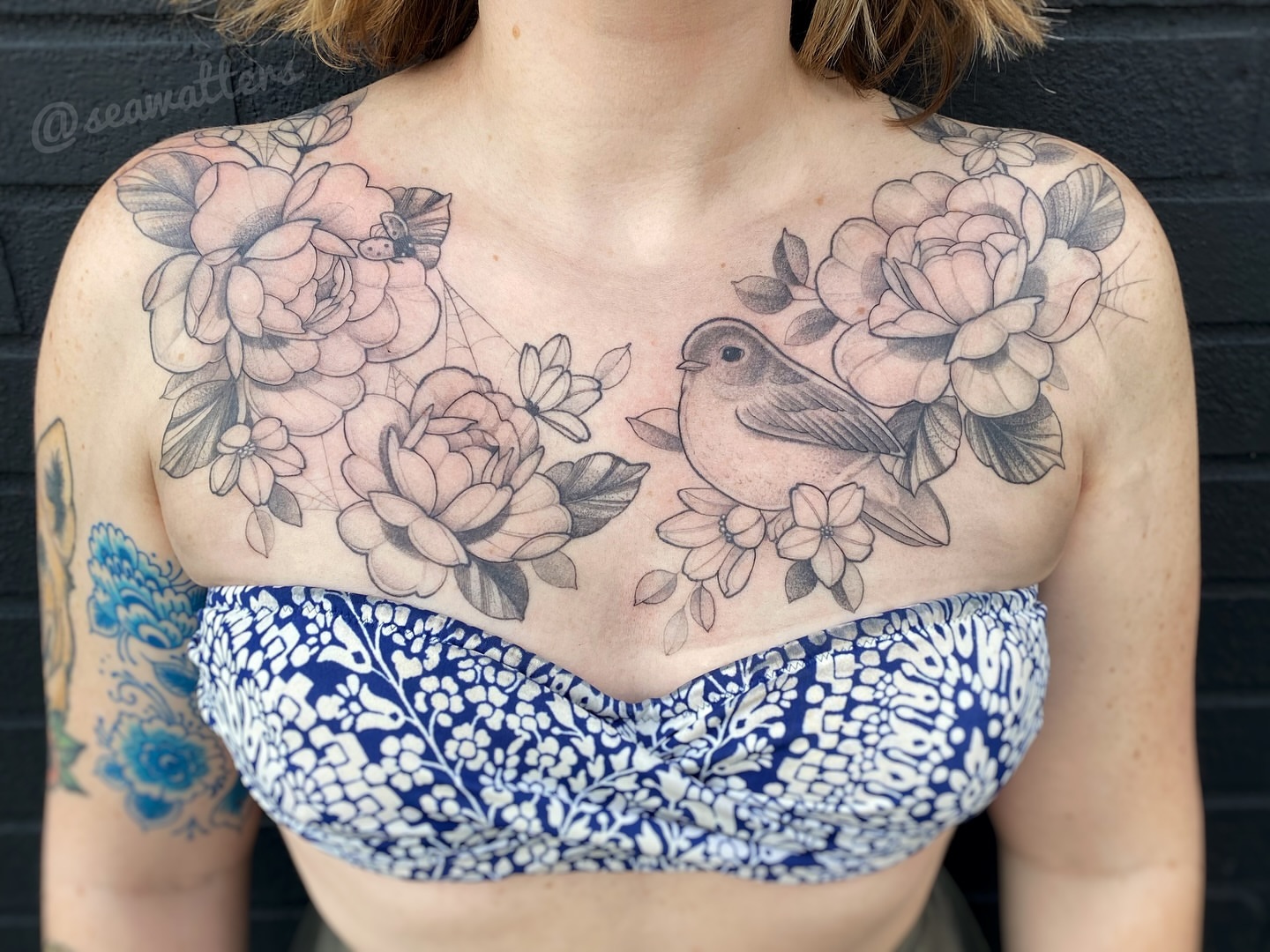 Flowers and bird black and grey tattoo on the chest by Caitlin Watters