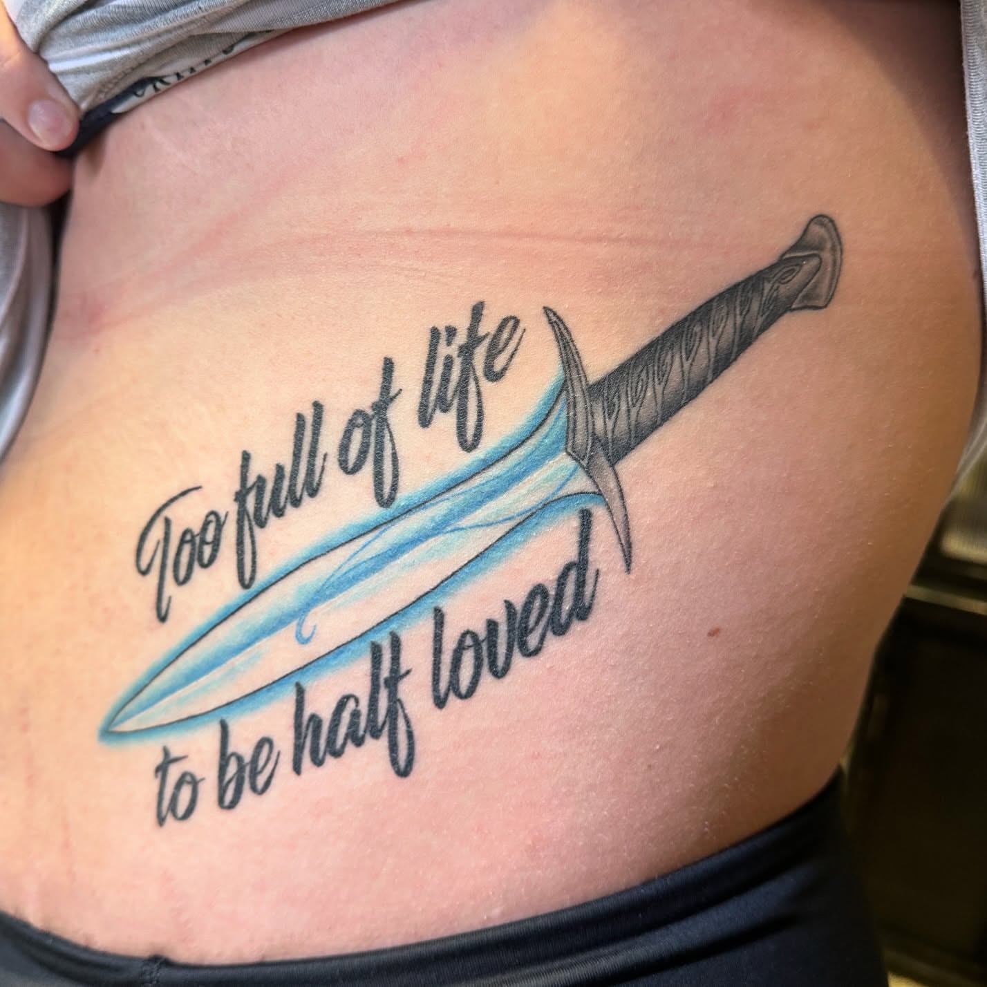 Sword and text black and grey tattoo on the ribs by (Joshua) Van Cummings