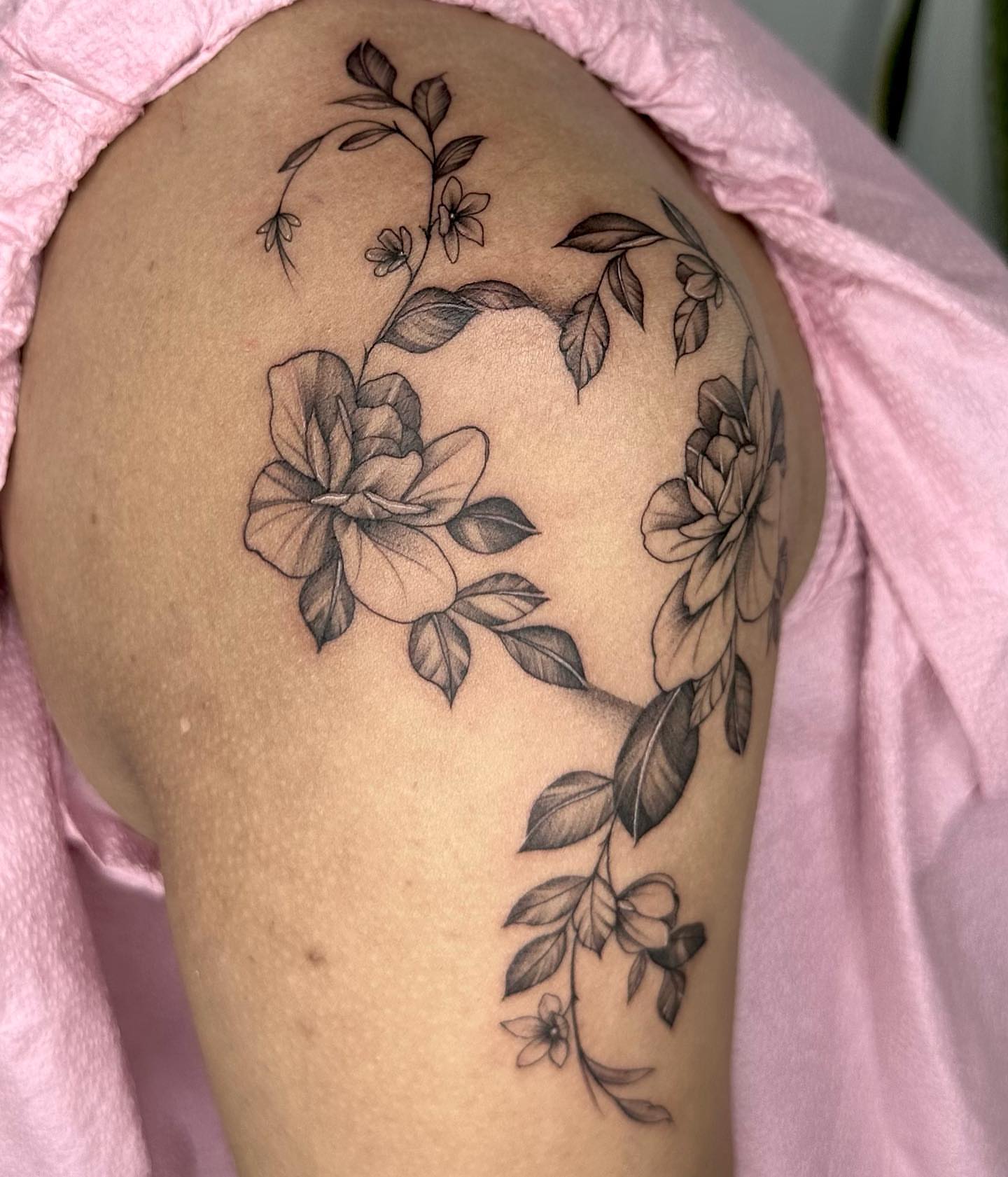 Floral arrangement black and grey tattoo on the shoulder by Sophia Delfino