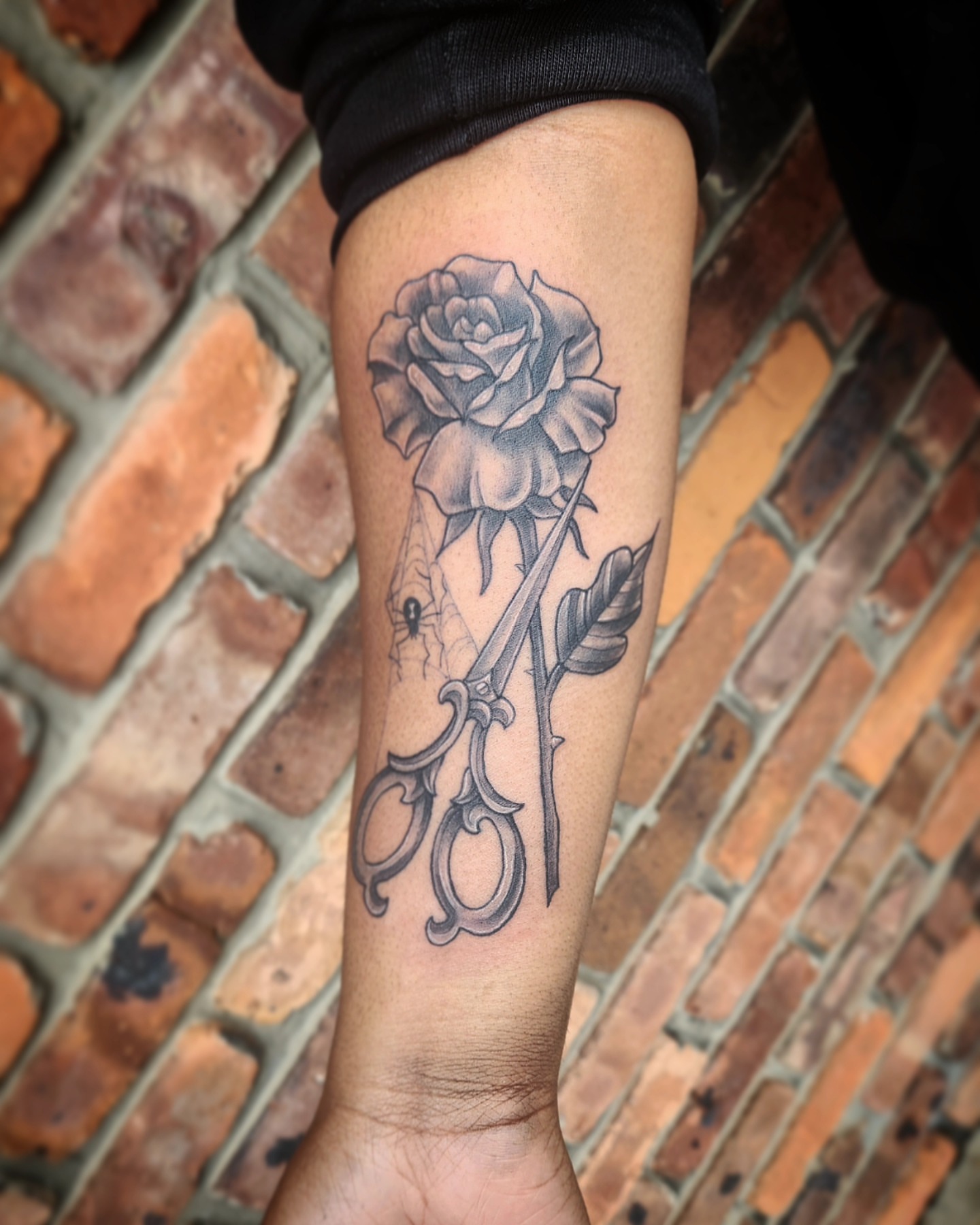Scissors and rose black and grey tattoo on the forearm by Jennalea