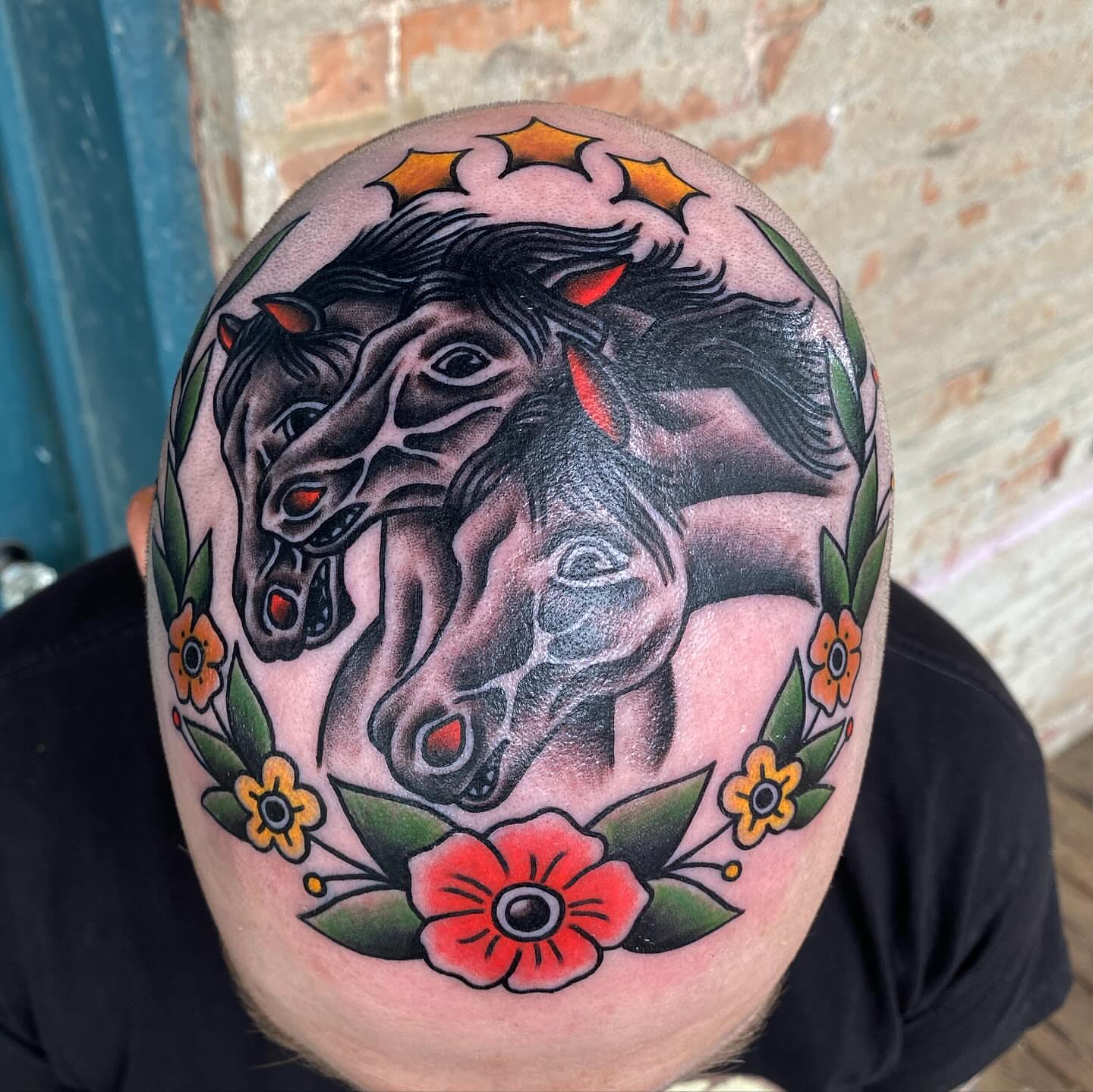 Horses and flowers American traditional tattoo on the shoulder by kenneth nash