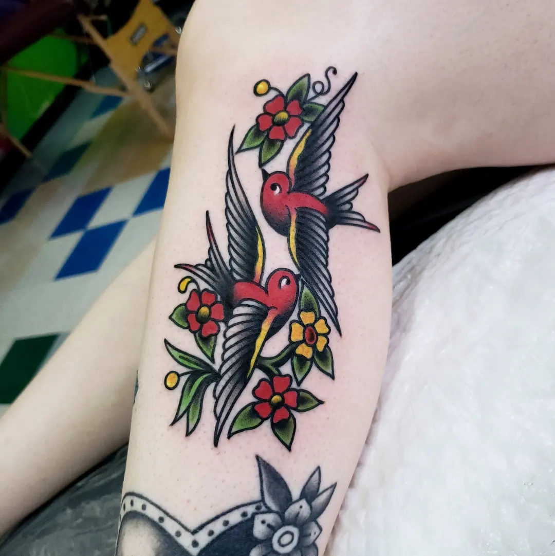 Birds and flowers American traditional tattoo on the forearm by Jake Lee