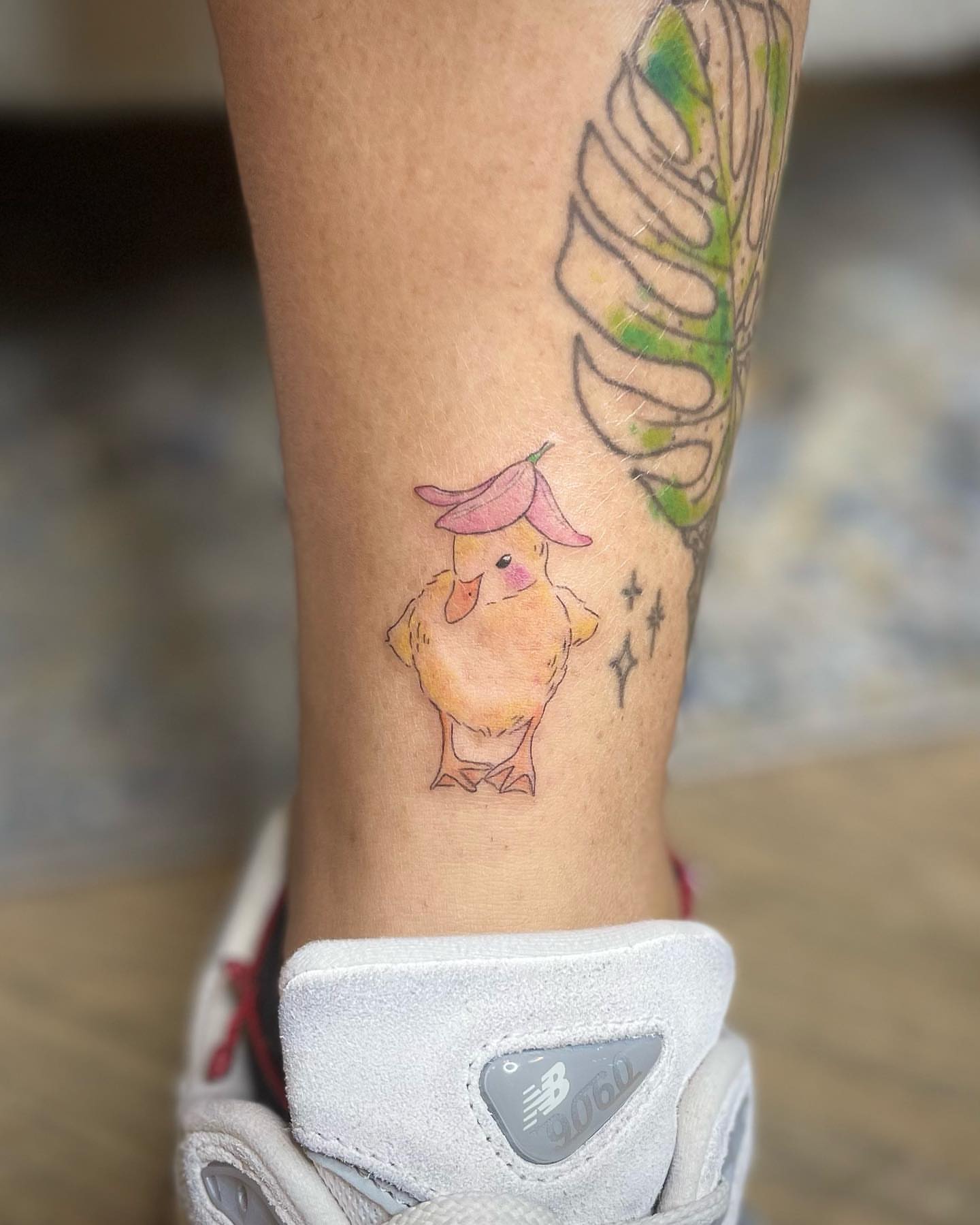 Chicken with hat watercolor tattoo on the calf by Jennifer Fuster