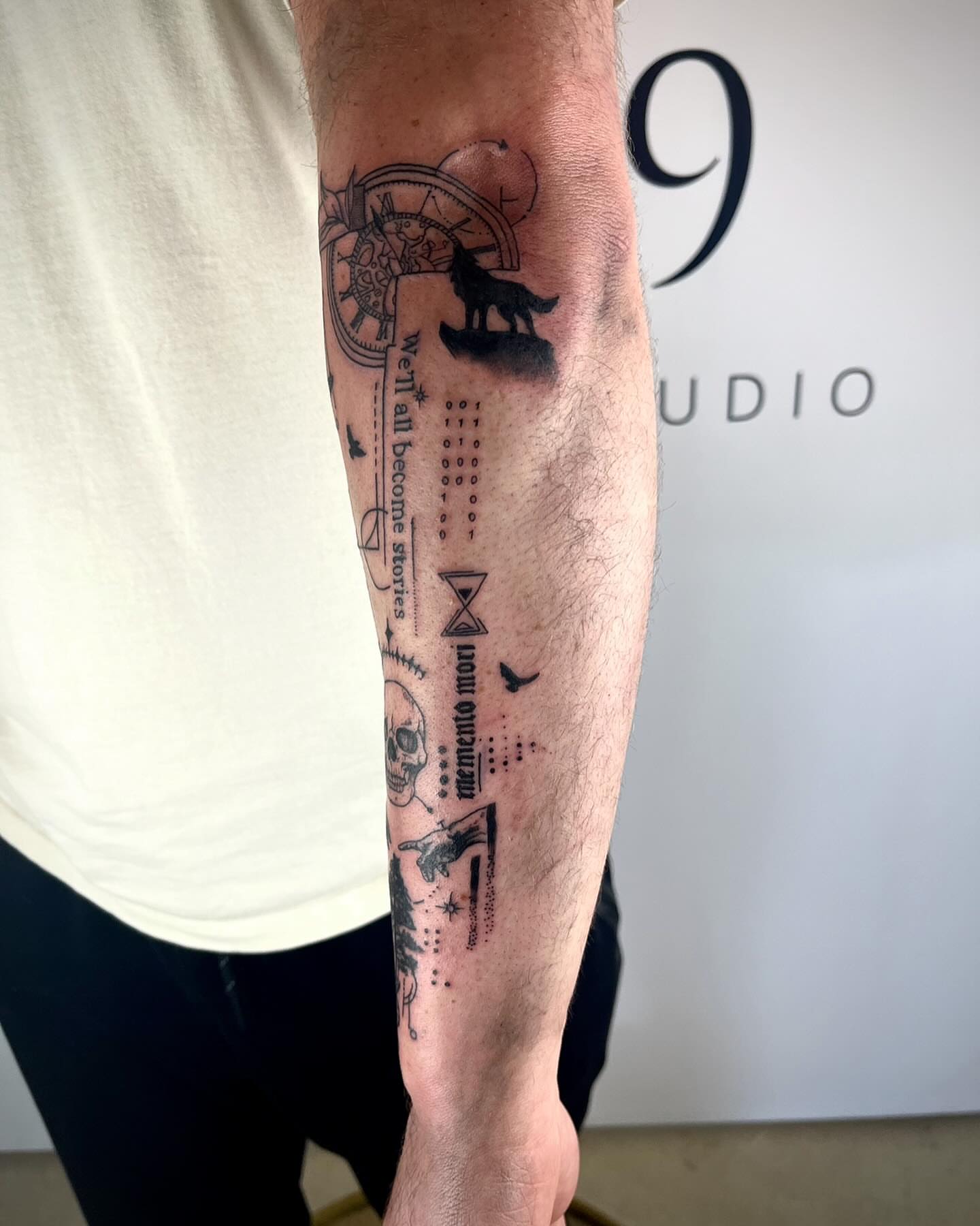 Wolf and clock black and grey tattoo on the forearm by Deville Pinson