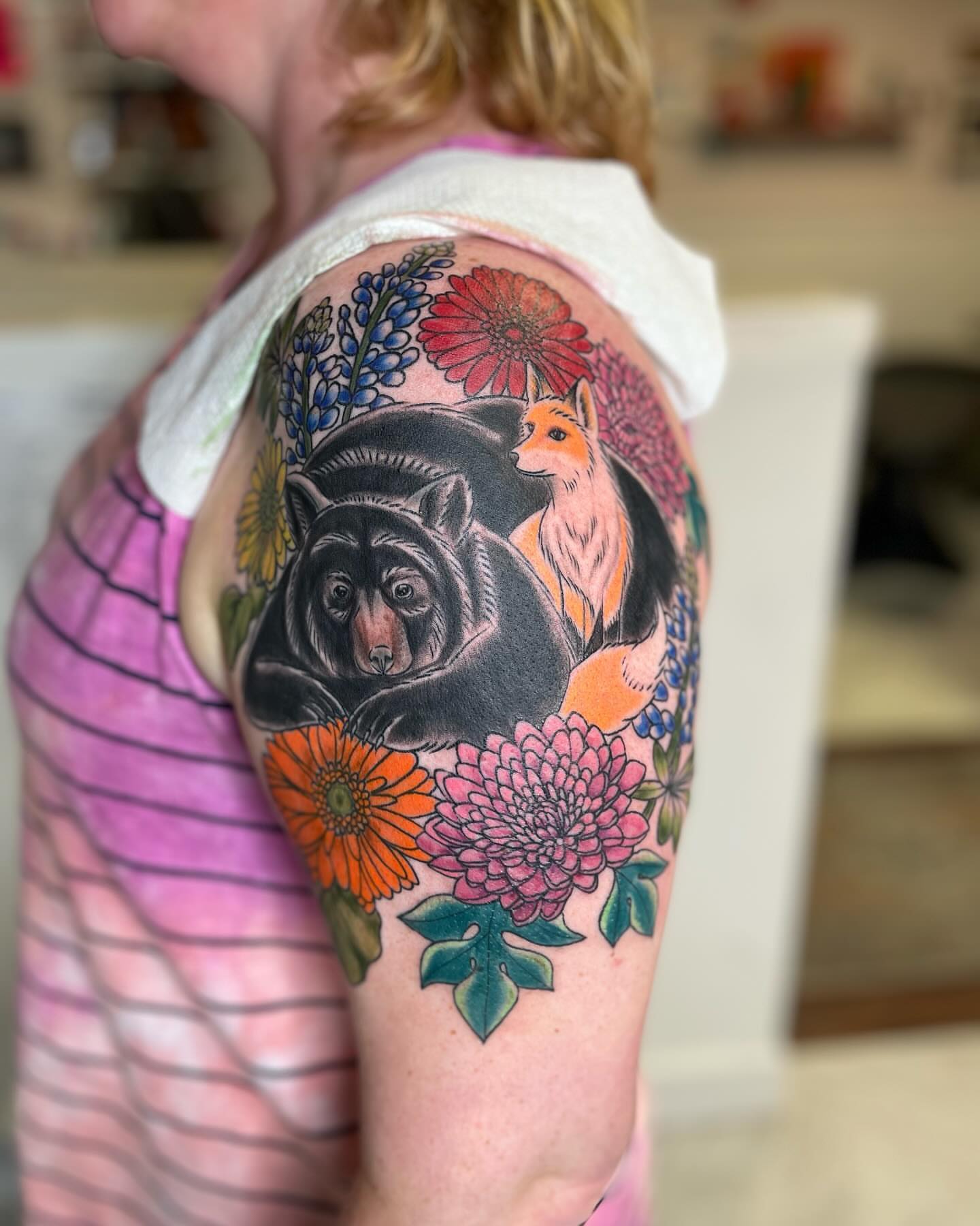 Bear and fox with flowers new school tattoo on the shoulder by Michelle