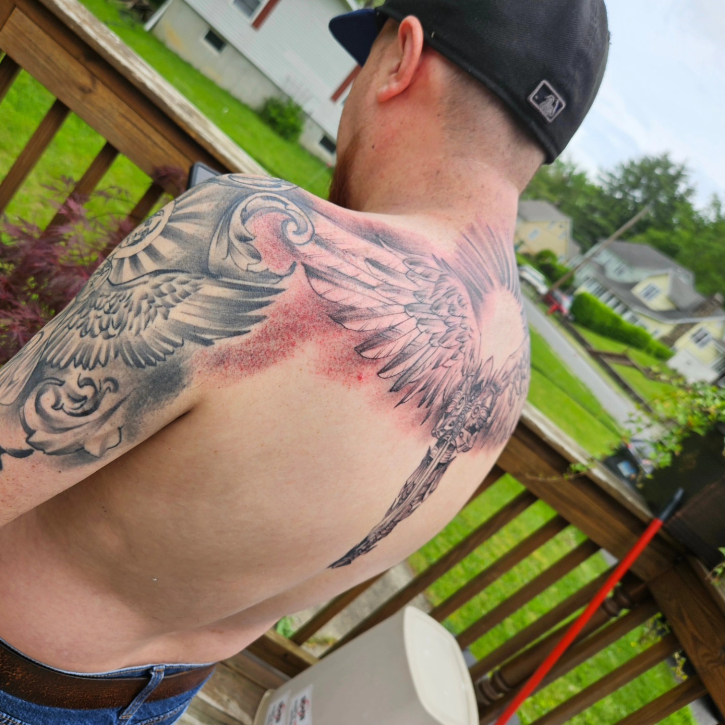 Wings and skull realism tattoo on the shoulder by German Romero-Rendon