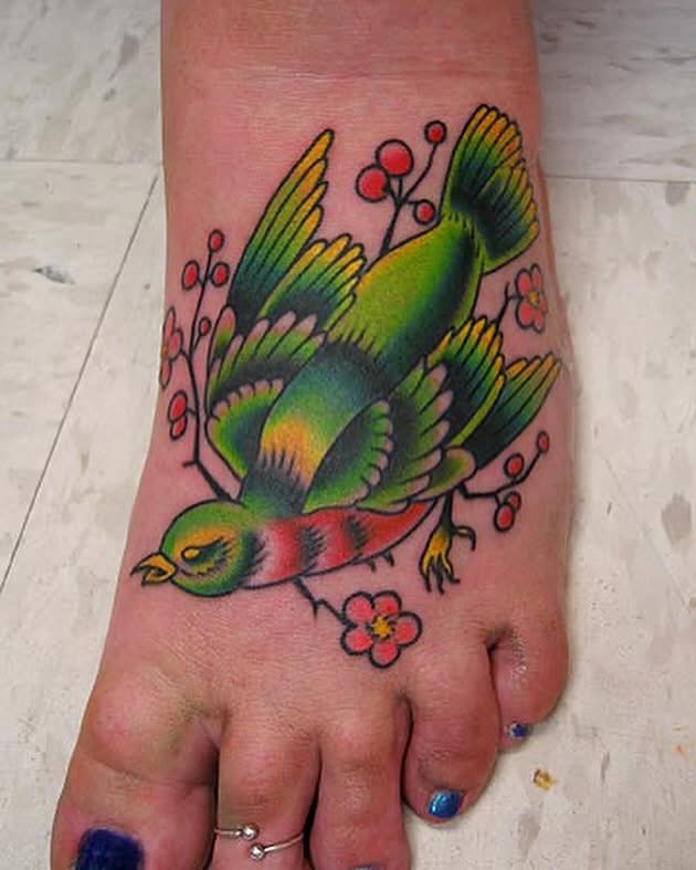 Bird and flowers American traditional tattoo on the foot by Erick Lynch, Cambridge, Massachusetts