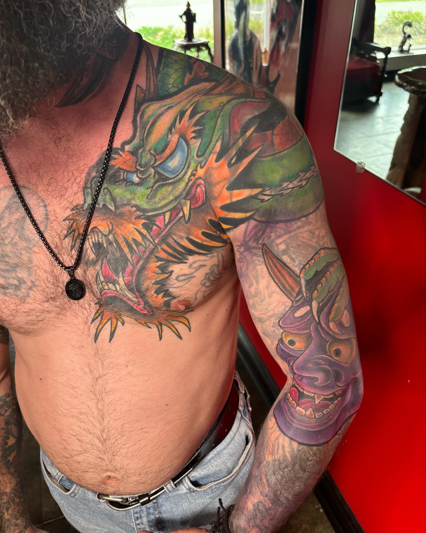 Dragon and mask japanese irezumi tattoo on the chest by Bobby Glennon