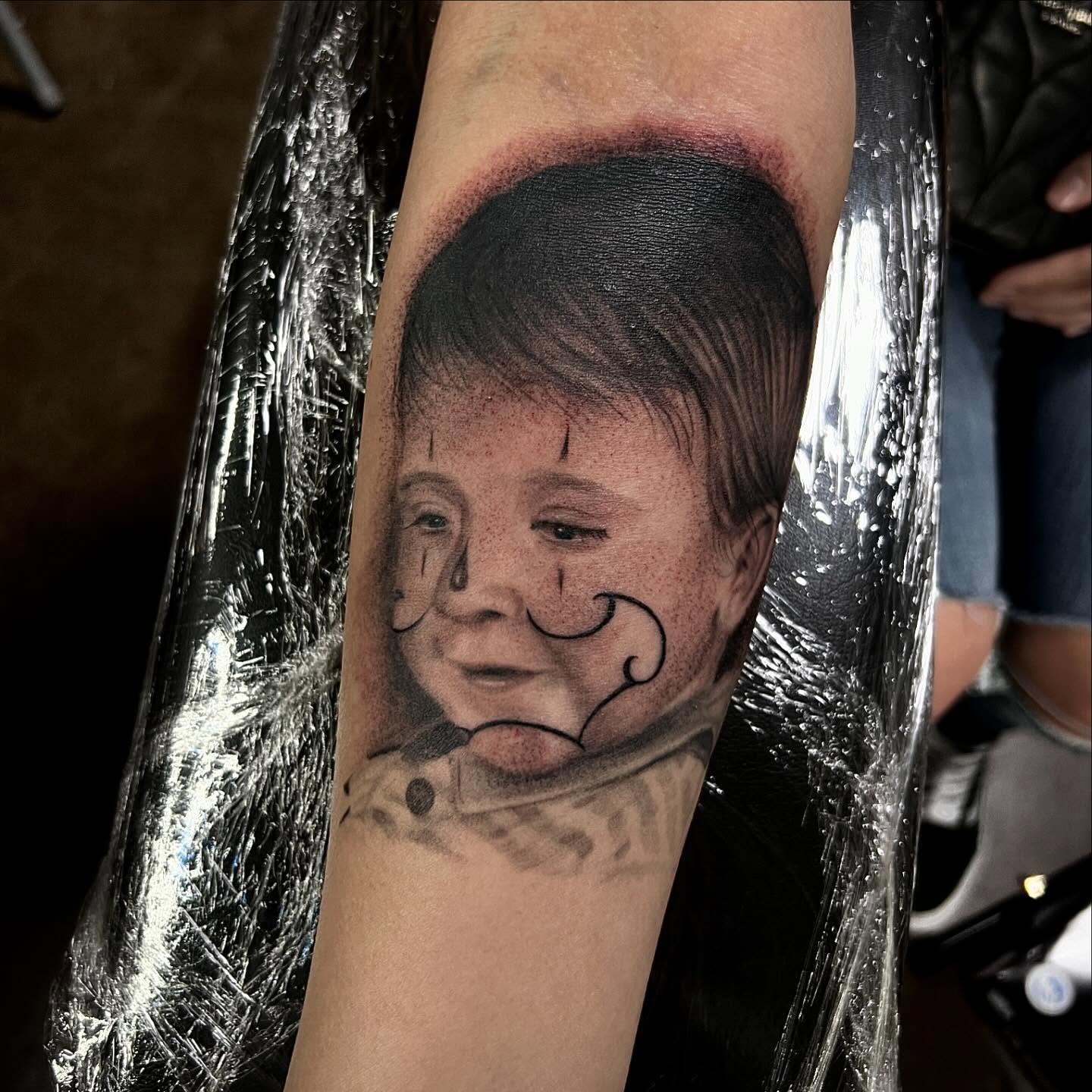 Child's face realism tattoo on the forearm by Joey Moreno