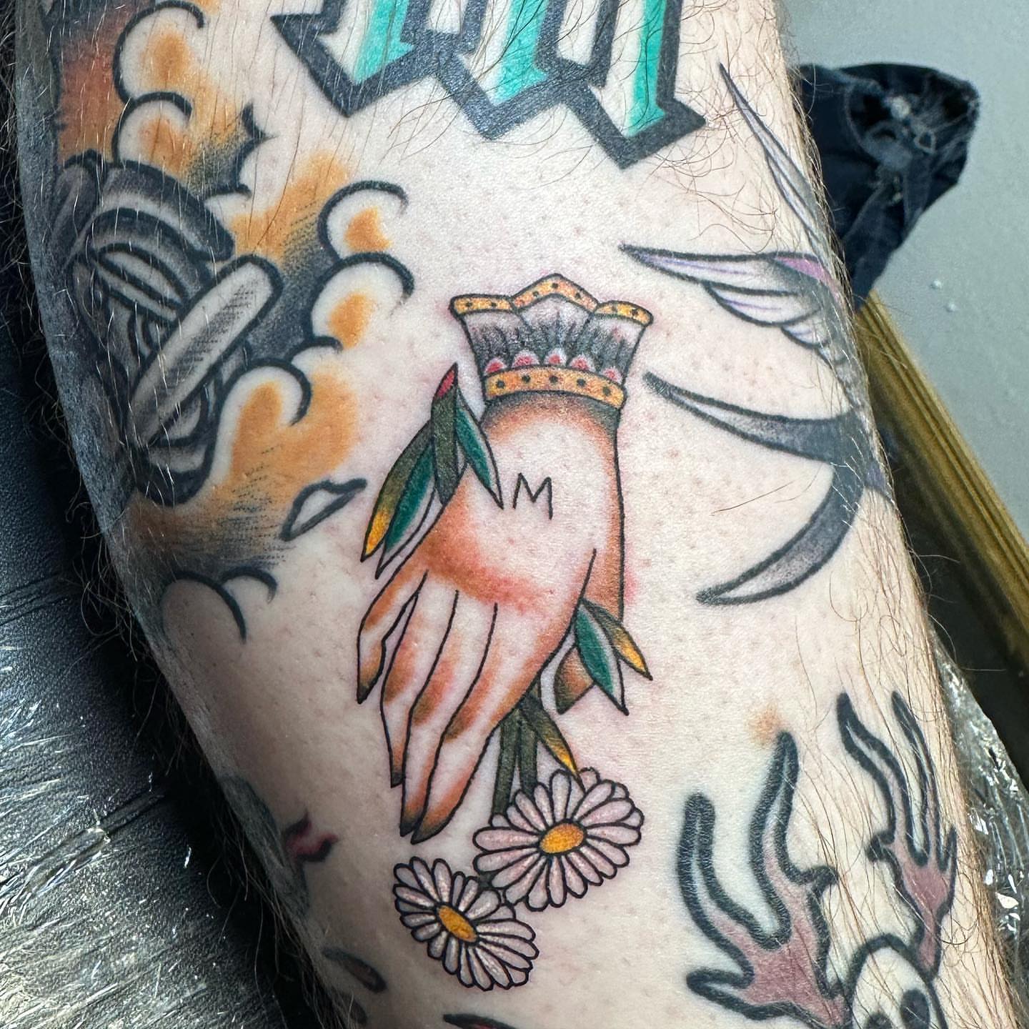 Hand with crown American traditional tattoo on the forearm by Gabby Tolley🌛