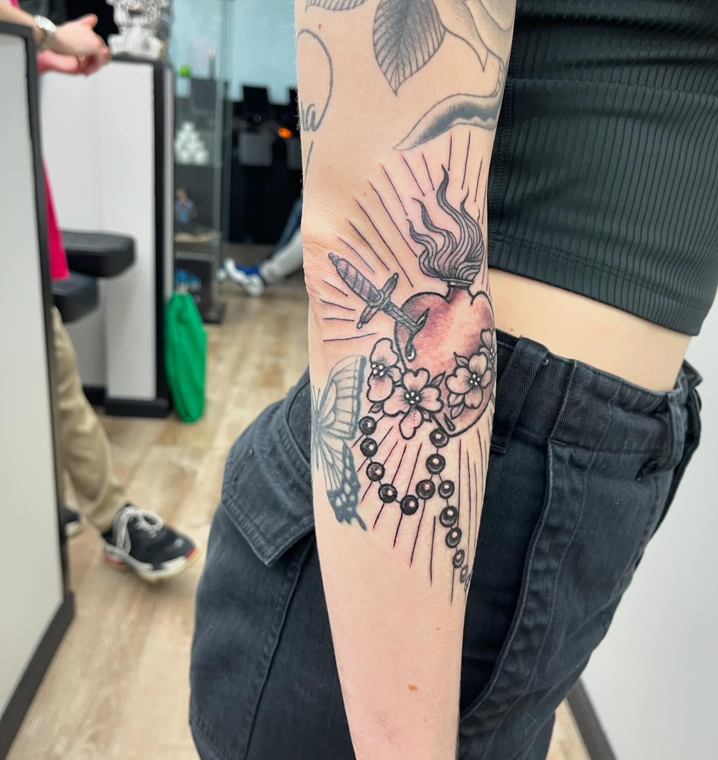 Heart with dagger and flowers dotwork tattoo on the forearm by Alejandro Juarez