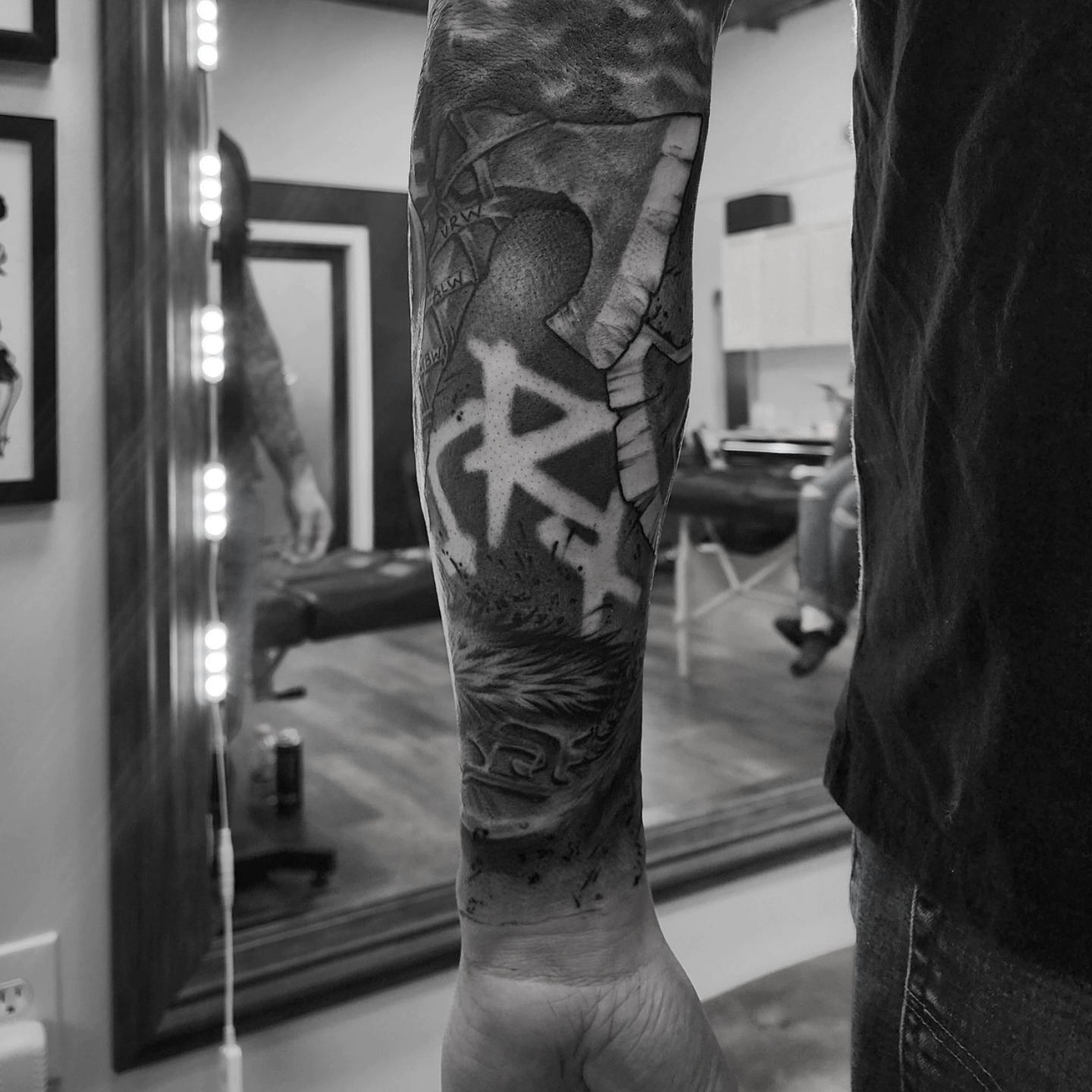 Graffiti-style lettering black and grey tattoo on the forearm by Dani Ryan