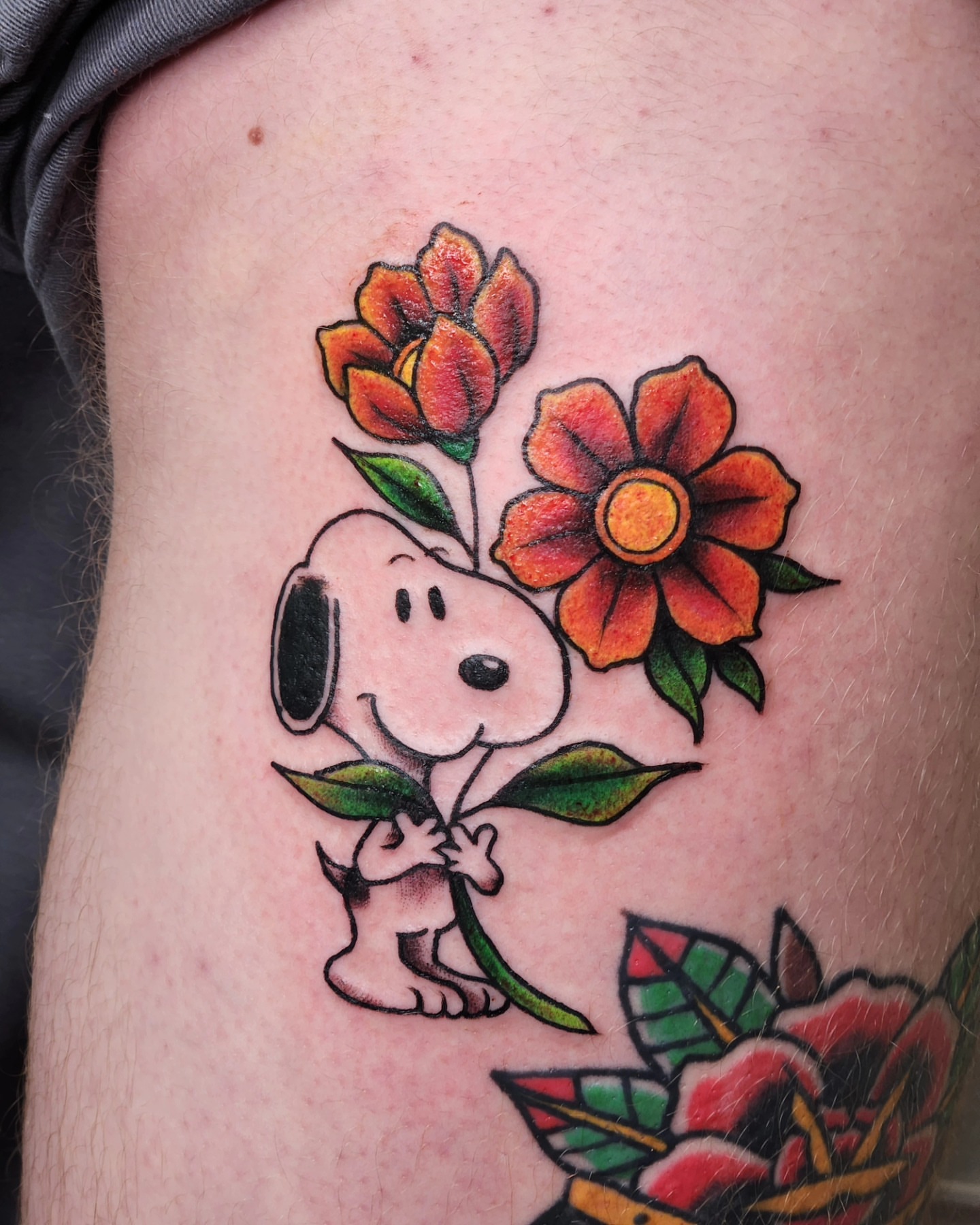 Snoopy with flowers American traditional tattoo on the forearm by Audrey Luther