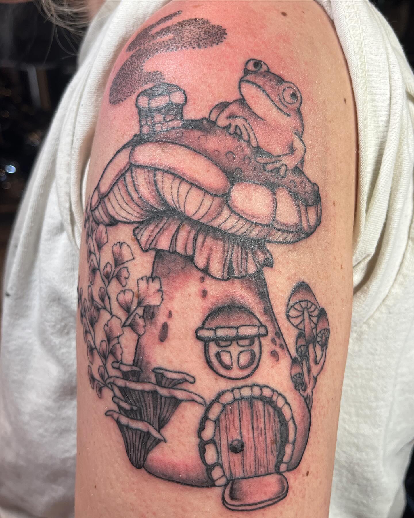 Frog house black and grey tattoo on the upper arm by ✩ 🕯️☾༺♰ gracey ༻☽🕯️✩