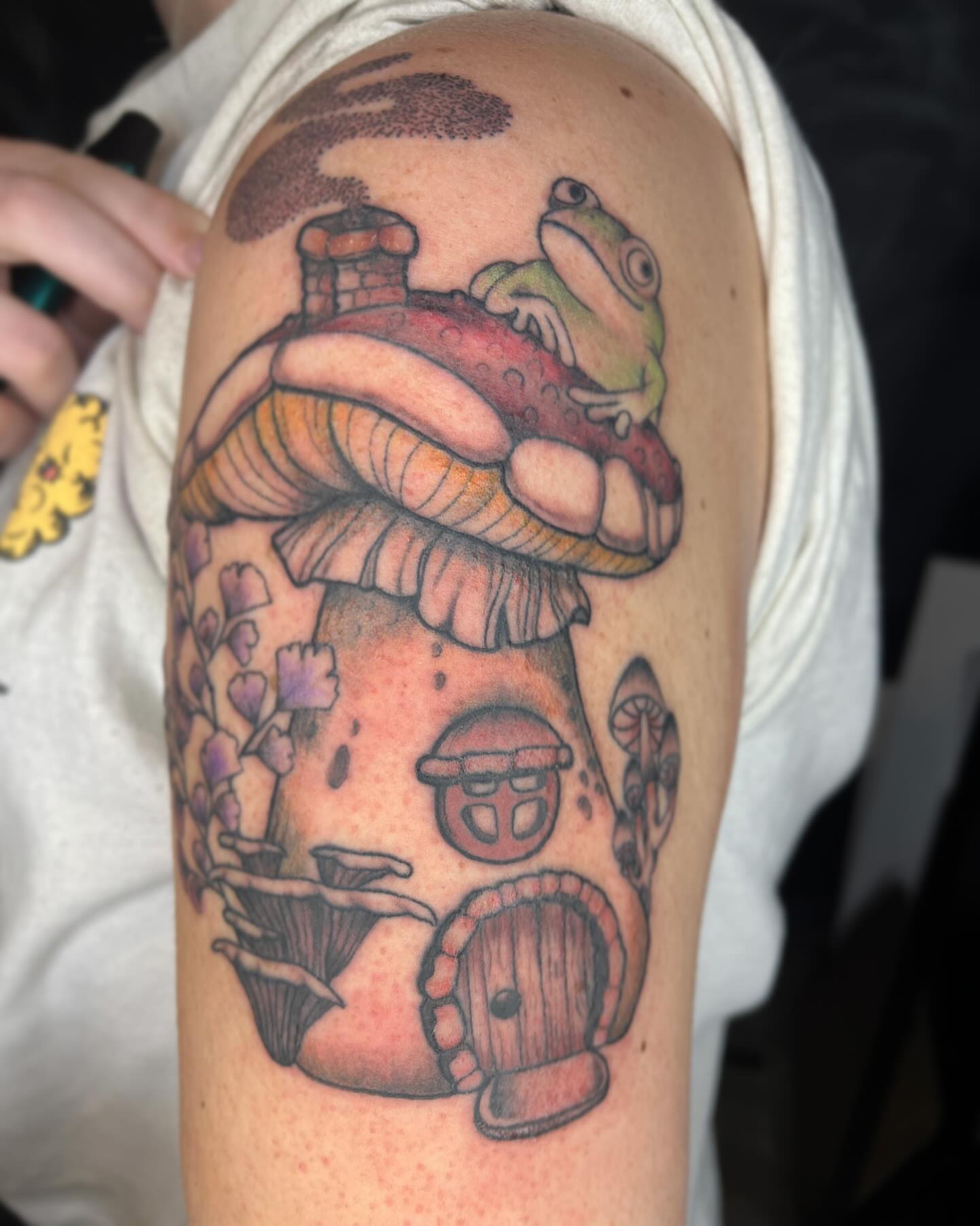 Frog on mushroom house new school tattoo on the upper arm by ✩ 🕯️☾༺♰ gracey ༻☽🕯️✩