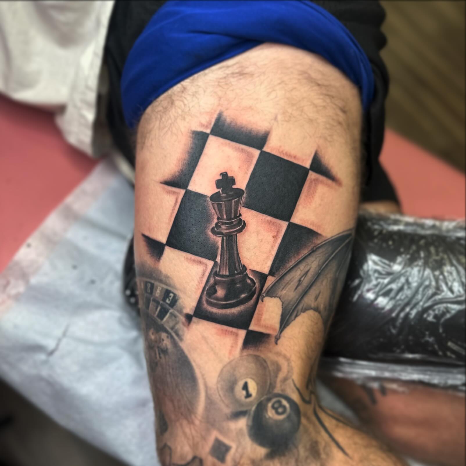 Chessboard and king geometric tattoo on the thigh by Diana Kunz