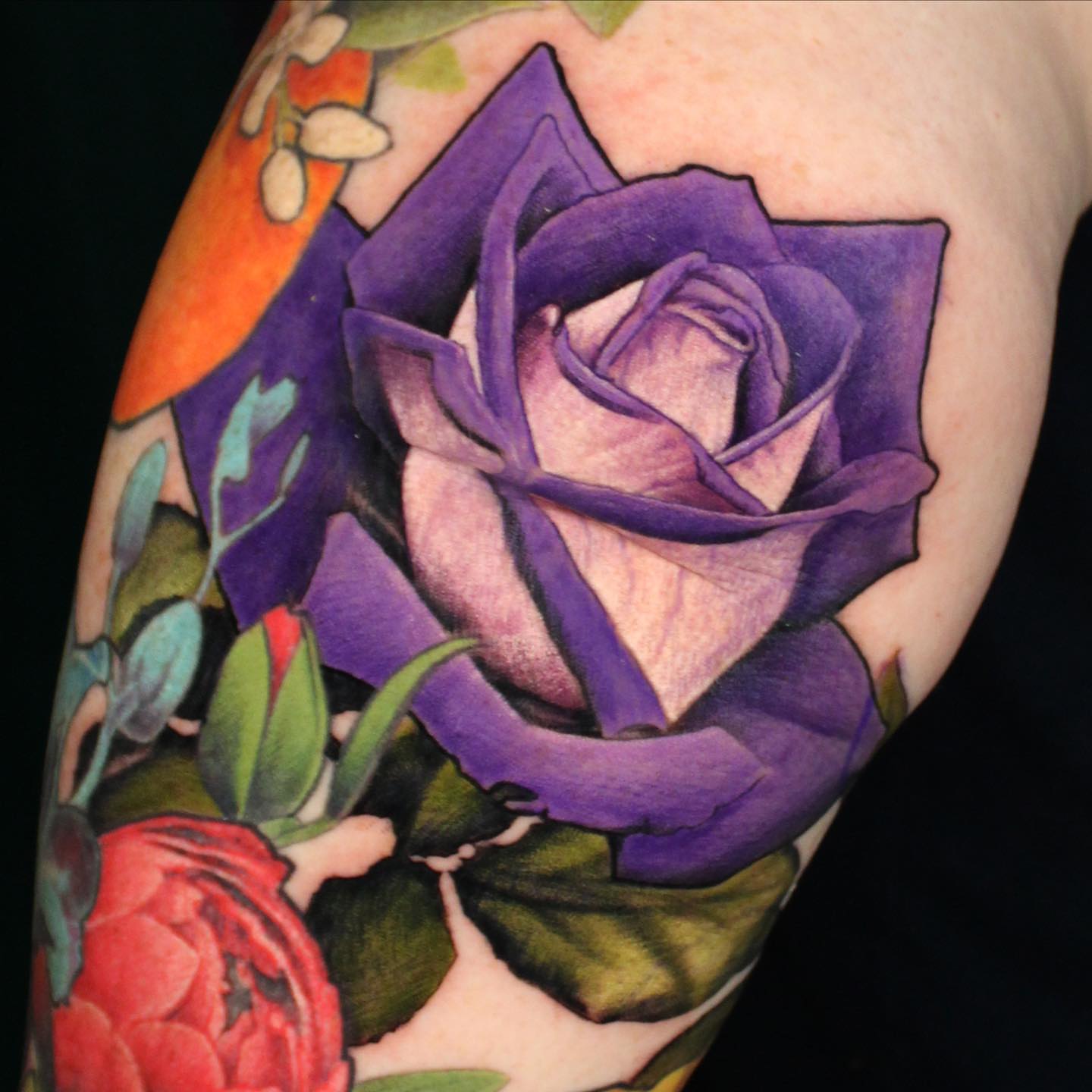 Purple rose realism tattoo on the forearm by Ericksen Linn
