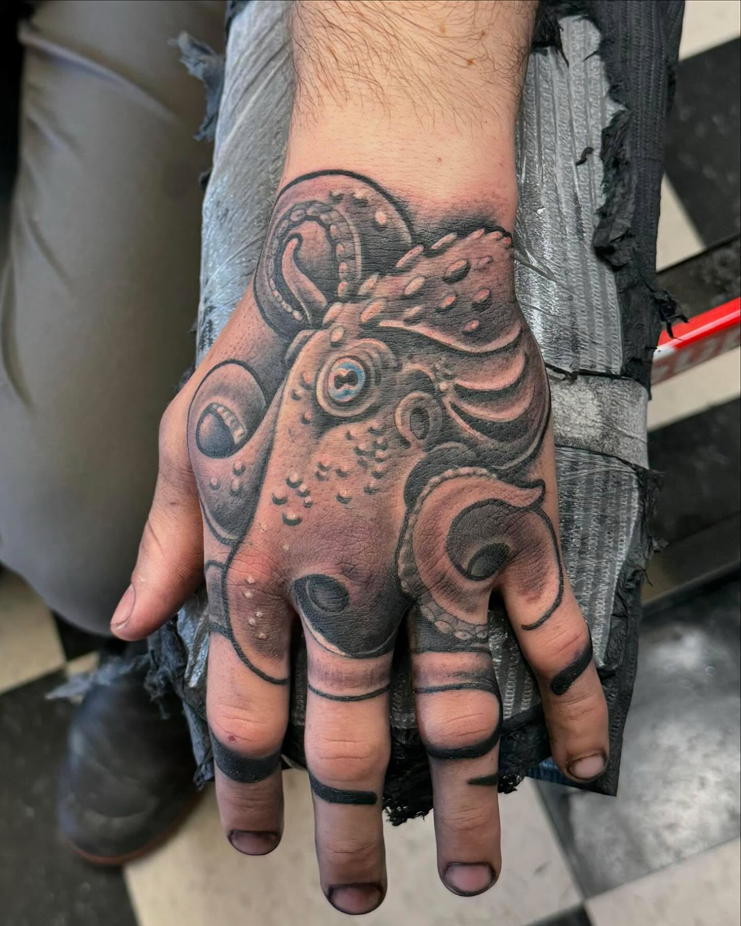 Octopus realism tattoo on the hand by Don Robison