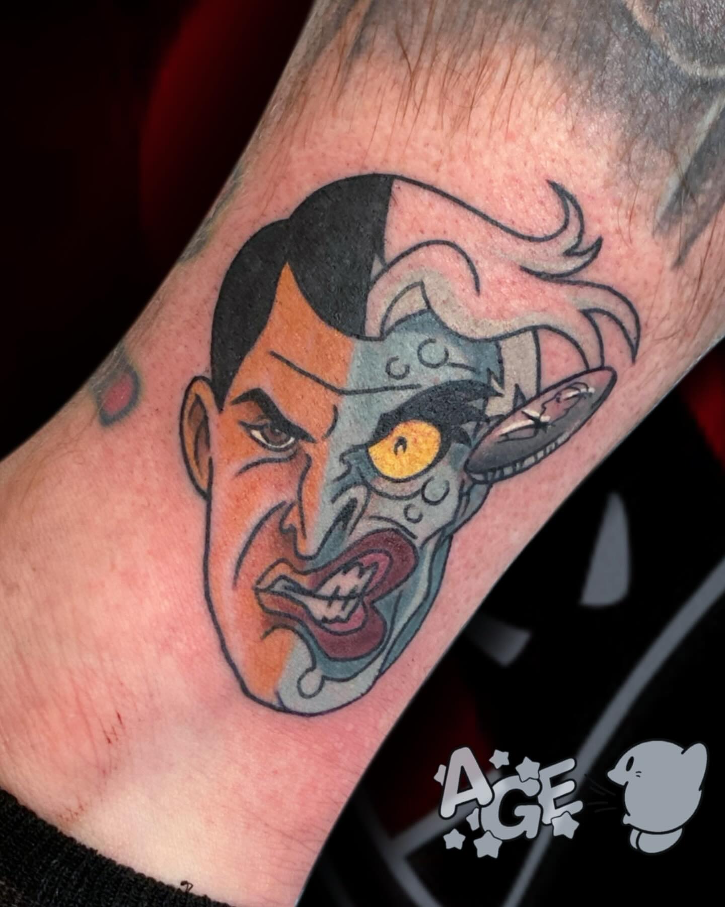 Angry face American traditional tattoo on the forearm by Otaku and Gamer Tattooer