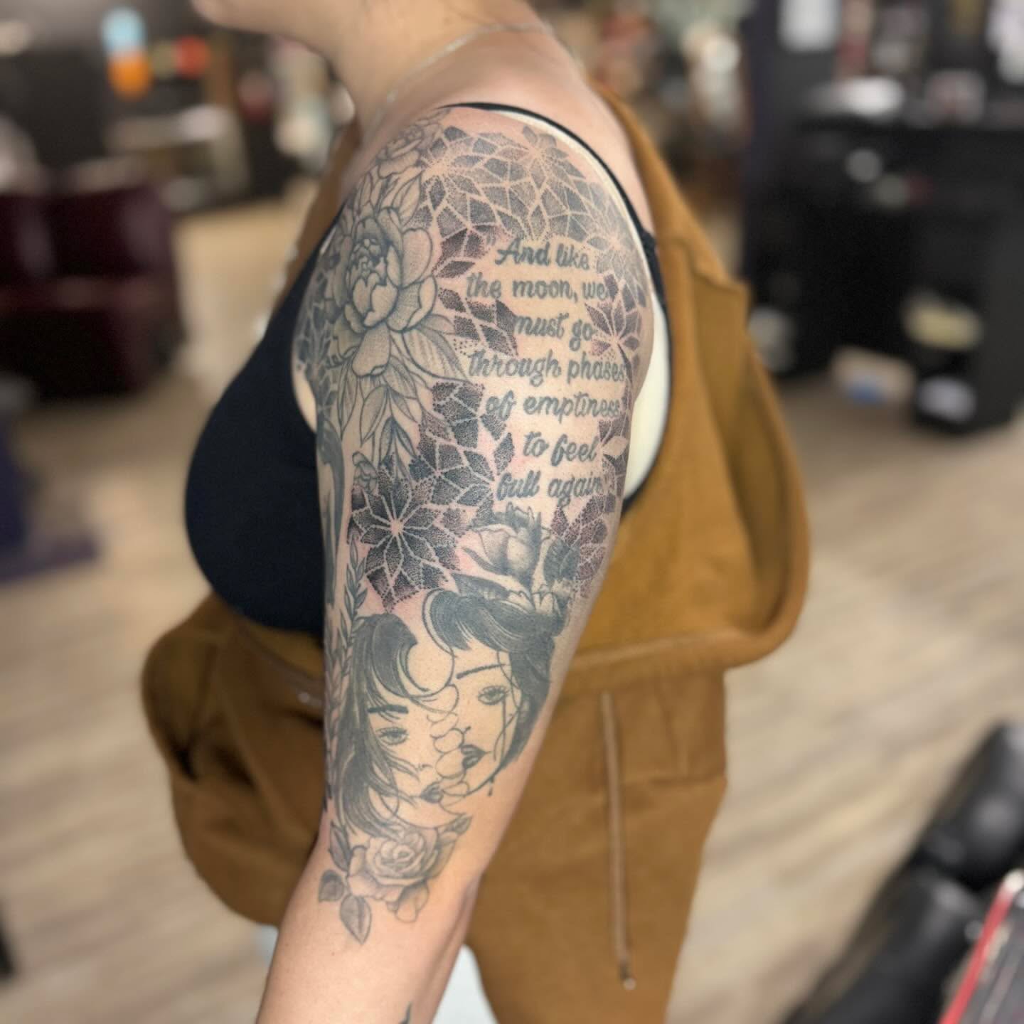 Moon phases and floral fine line tattoo on the forearm by Steve