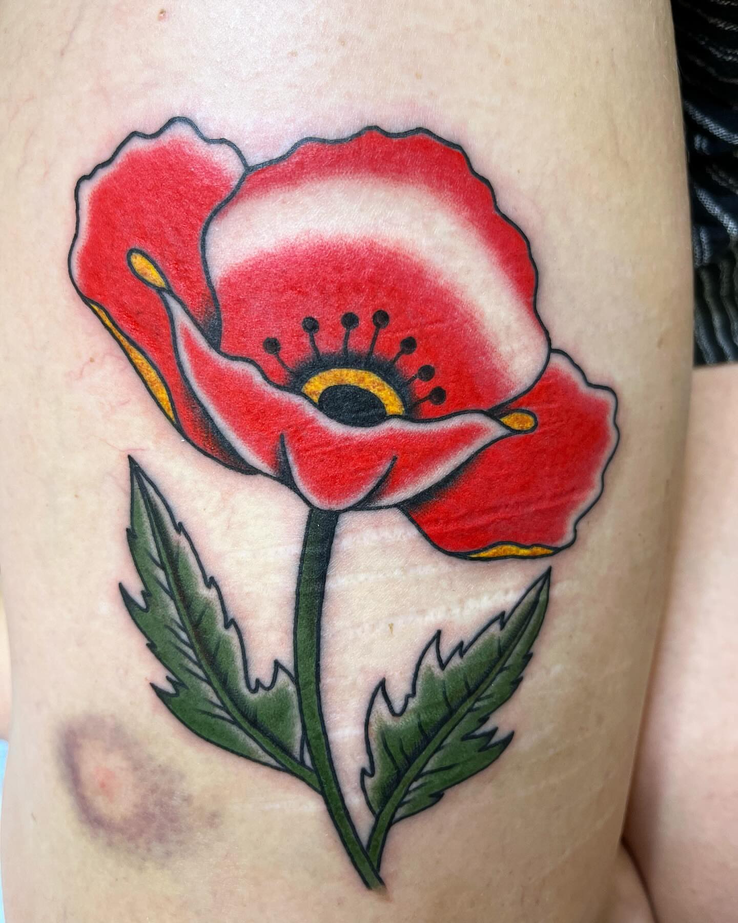 Red poppy American traditional tattoo on the thigh by Pedroux M.