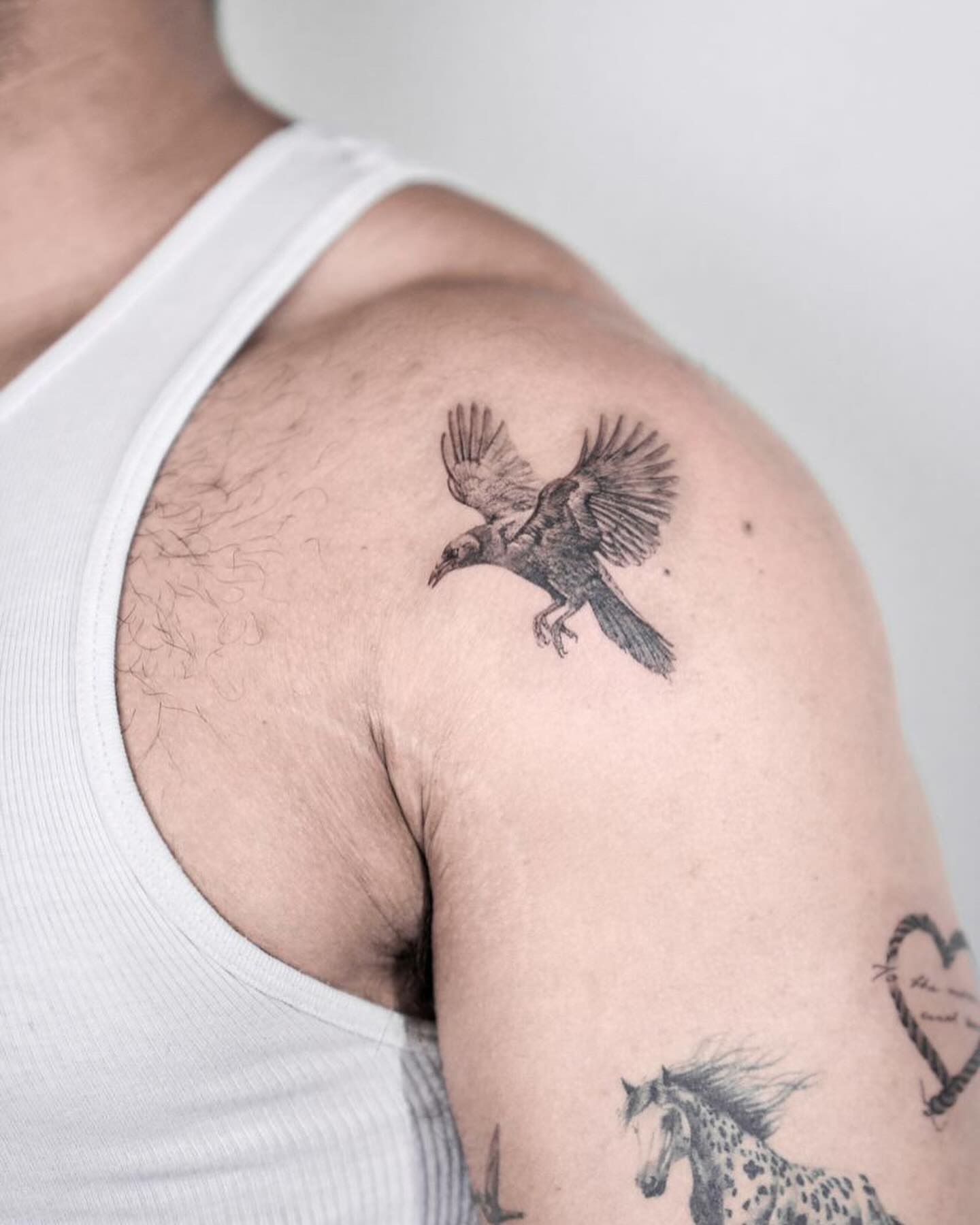 Crow black and grey tattoo on the shoulder by Tattoo artist LA ། Fine line, Micro realism